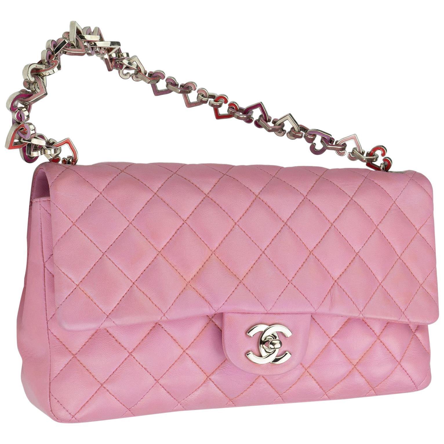 Chanel Limited Edition Pink Valentine Heart Charm Classic Flap
2004 {VINTAGE 14 Years} 
Pink quilted lambskin
Heart charm strap
Silver CC turnlock 
Classic back pocket
Pink logo microfiber interior
Interior zippered pocket 
Handle drop: 7.5