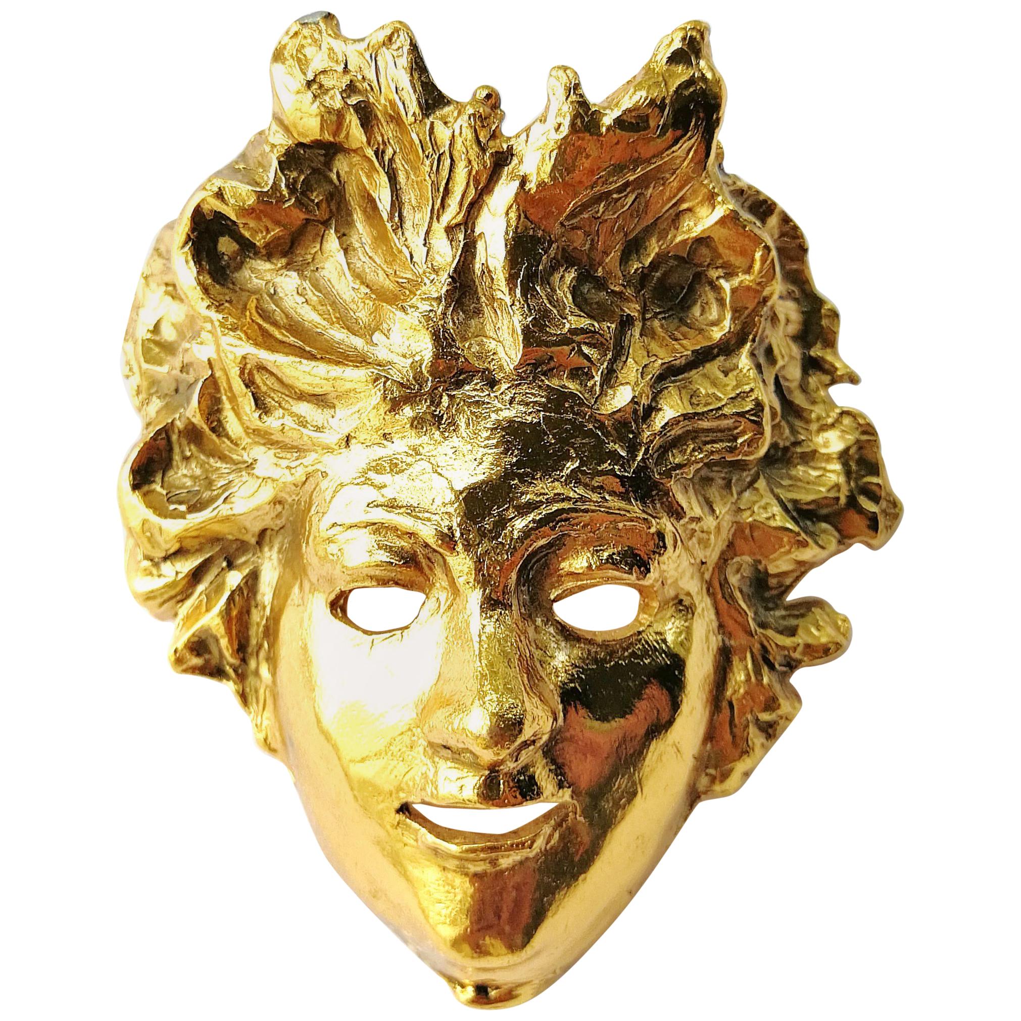 Gilded metal 'mask' brooch, Maison Goossens, 1990s, France.