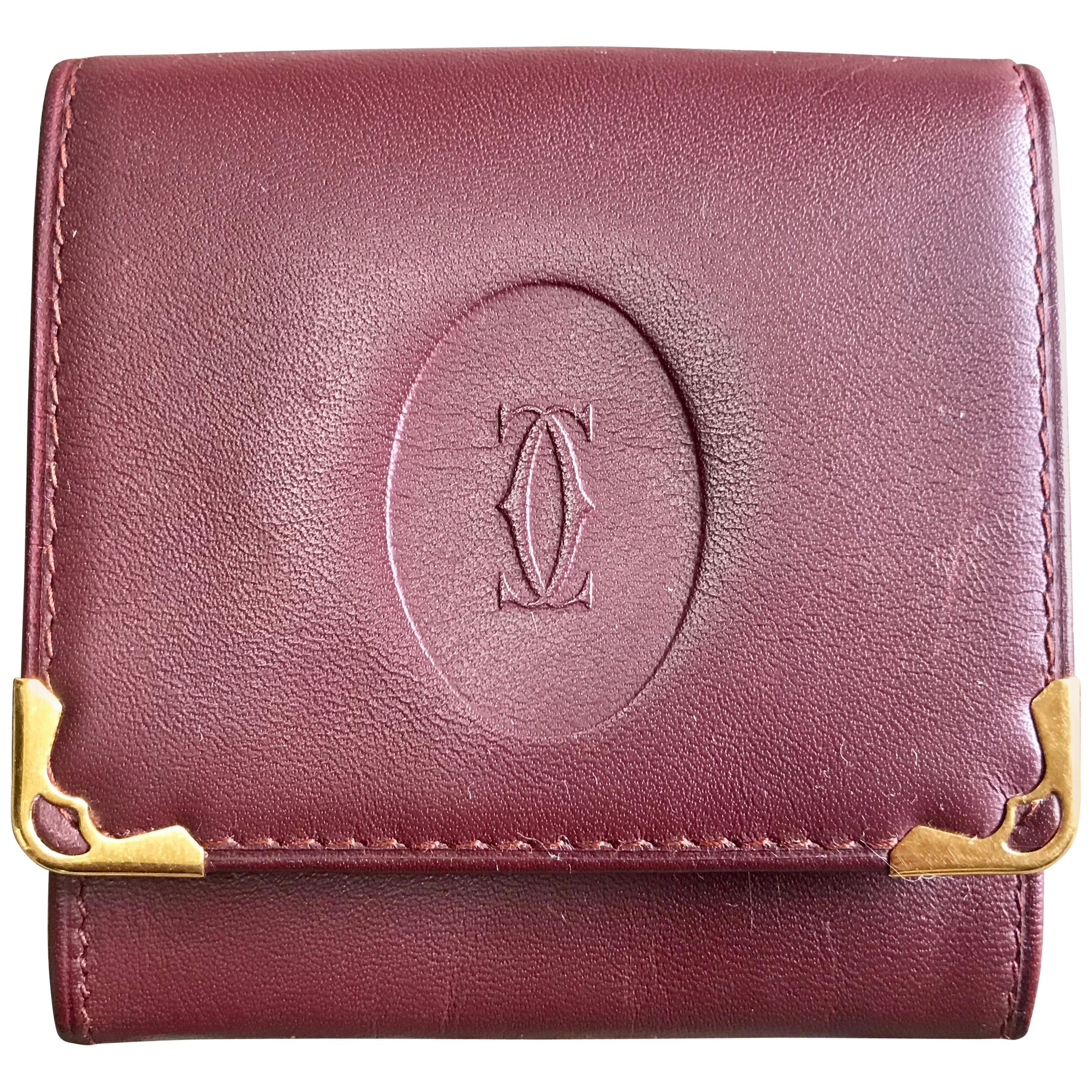 Vintage Cartier wine leather coin case with gold tone frames. must de Cartier. For Sale