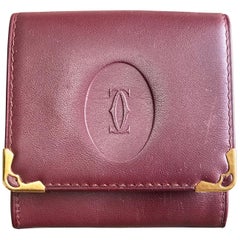 Retro Cartier wine leather coin case with gold tone frames. must de Cartier.