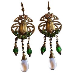 An Art Deco pair of Egyptian Revival brass earrings with Scarabs