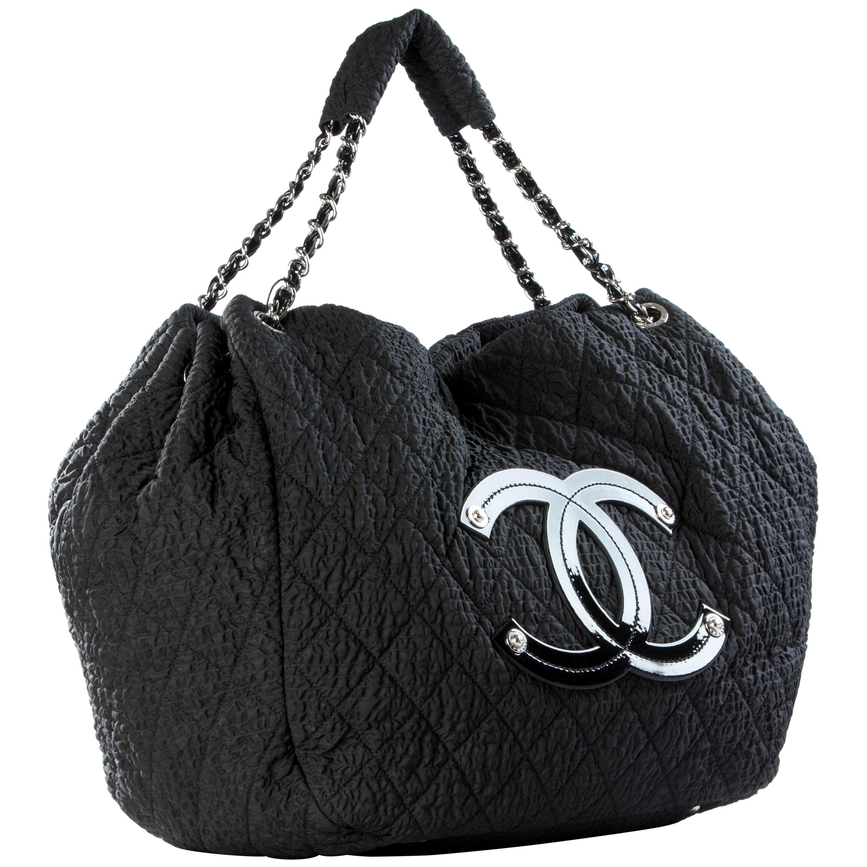 Chanel Travel Weekend Overnight Microfiber Tote Bag 

Year: 2010
Silver Hardware
Black texturized nylon
Patent leather CC stitched logo
Classic interwoven patent chain strap
Grey thick nylon interior lining
Zippered interior compartment
Additional