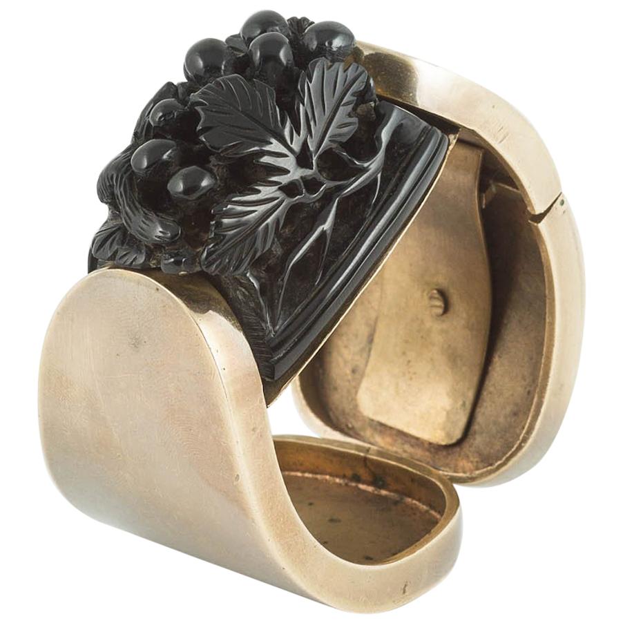 Black carved galalith, gilded metal clamper bangle and belt, French, 1920s/30s. For Sale
