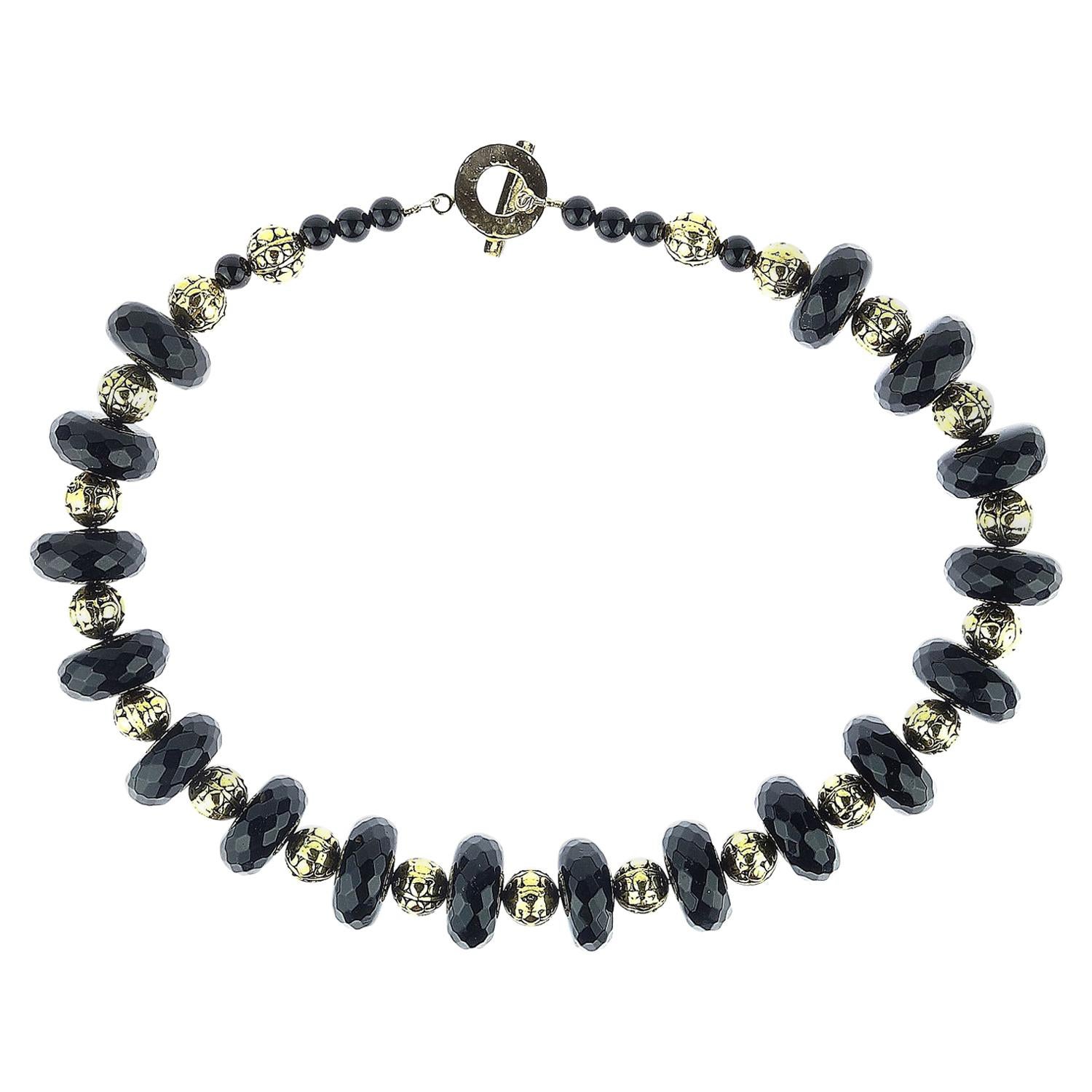 Wear this great necklace when you want to be noticed! This standout necklace in Black Onyx and detailed shiny Brass beads sits easily around your neck. The large highly polished and faceted Black Onyx rondels are 19mm and the Brass beads are 10mm.