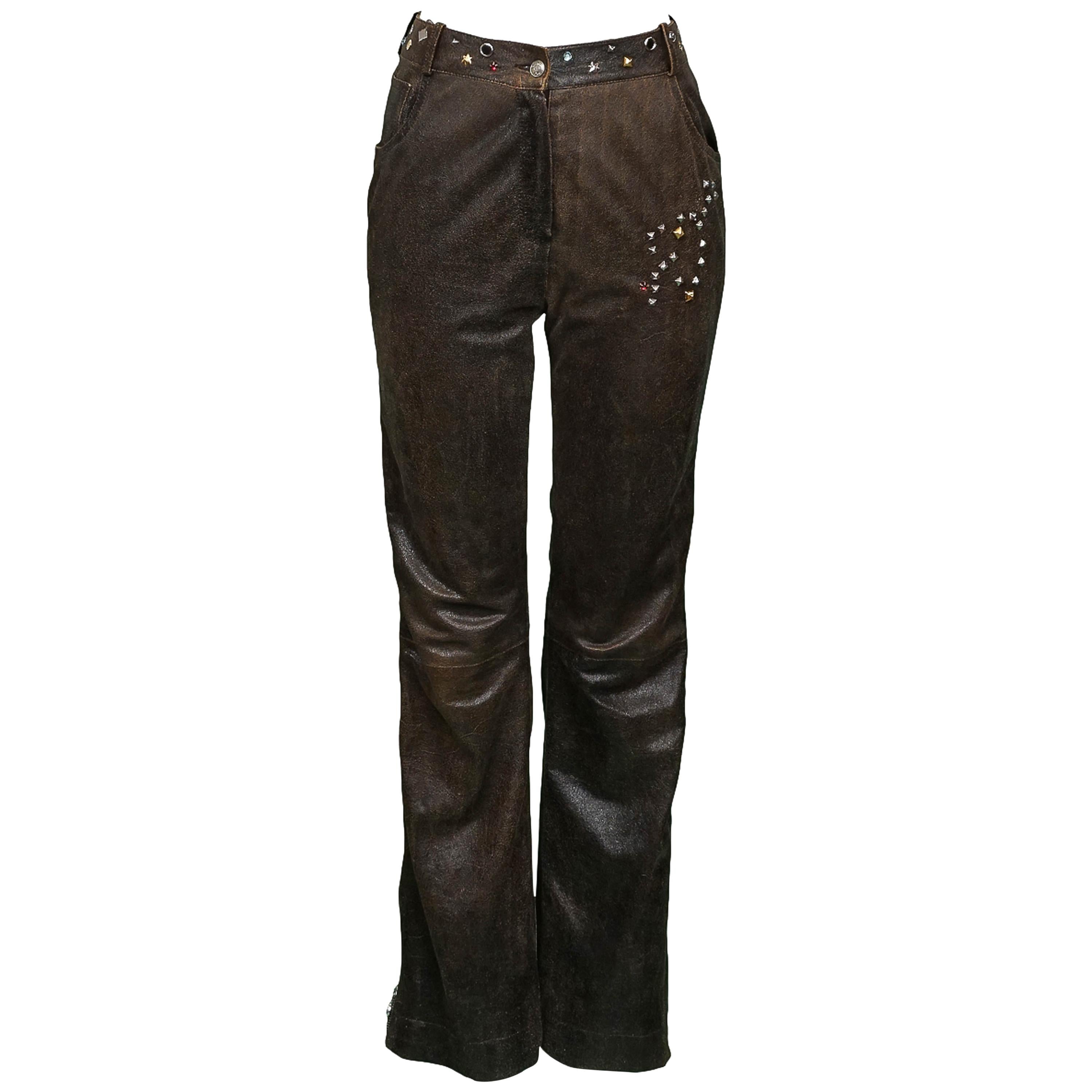 Vintage John Galliano for Christian Dior brown lambskin leather pants featuring gold & silver tone multi-shape studs, rhinestone embellishments and functional hem to pocket zipper side detail creating the ultimate slit. Runway piece from the