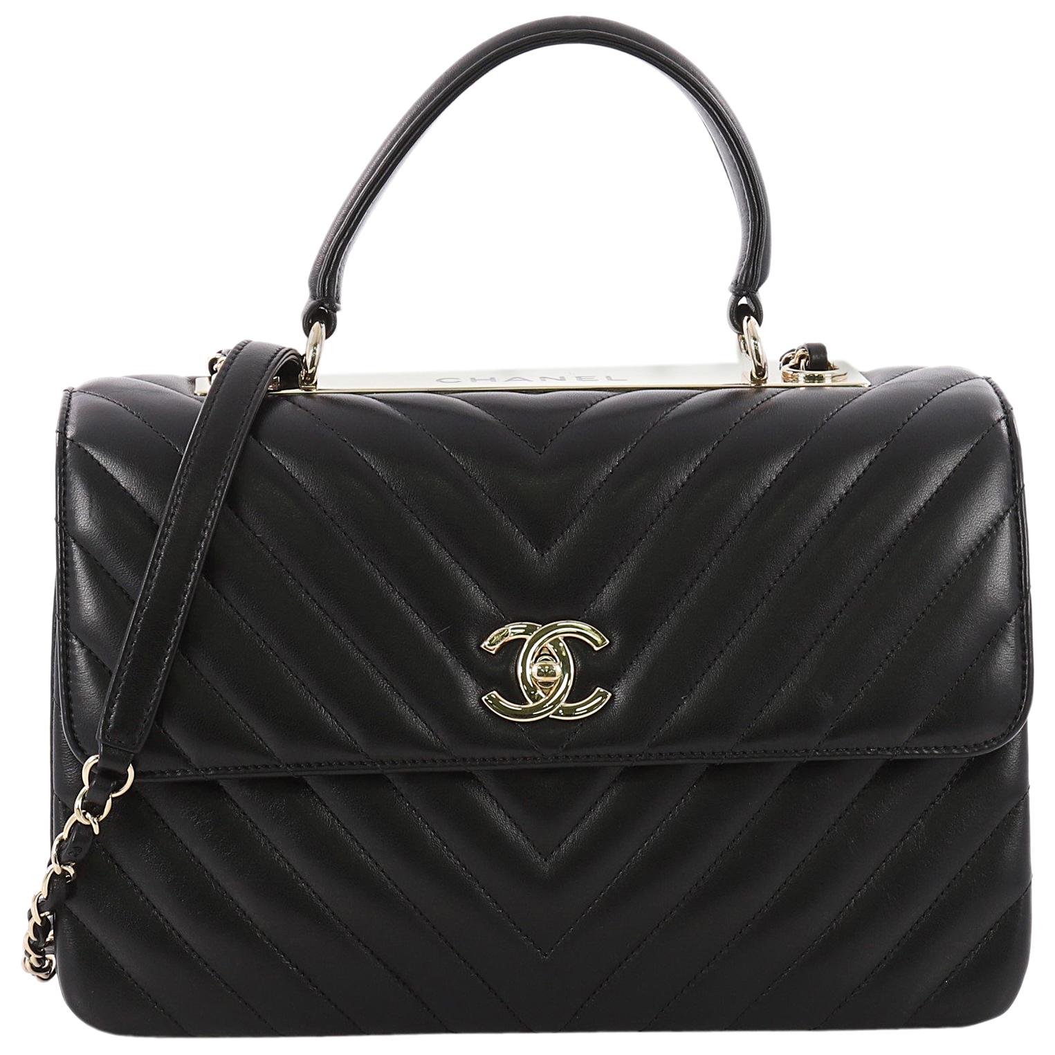 Flap bag with top handle, Lambskin & gold-tone metal, black — Fashion