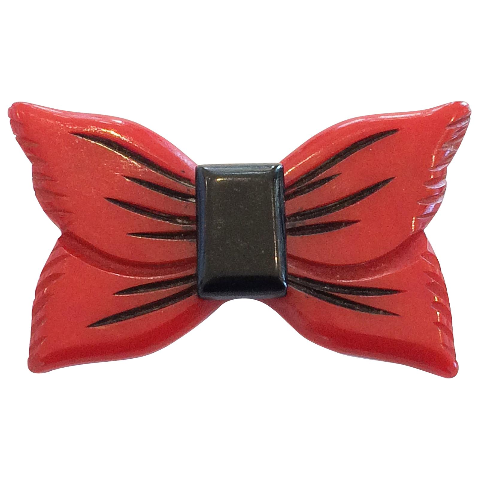 Art Deco Red Bakelite bow or ribbon brooch pin For Sale
