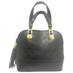 Gianni Versace Vintage black bolide shape bag with a tassel and sunburst motifs