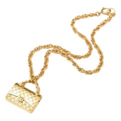 Vintage CHANEL golden chain necklace with classic 2.55 bag charm.