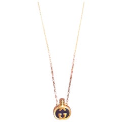 Vintage Gucci gold and navy round shape perfume bottle necklace with iconic logo