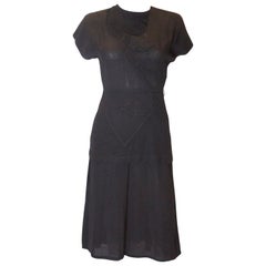 A vintage 1940s black peplum rayon day dress with embossed detail