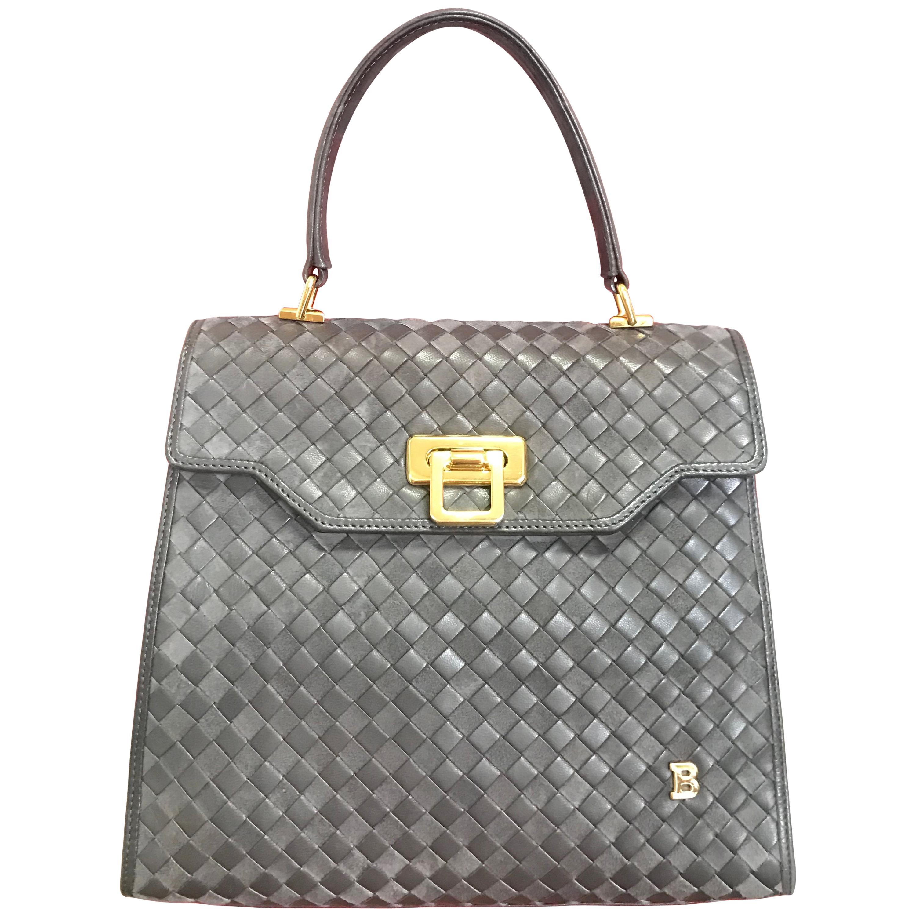 Vintage Bally taupe grey intrecciato leather kelly handbag with gold tone logo. For Sale