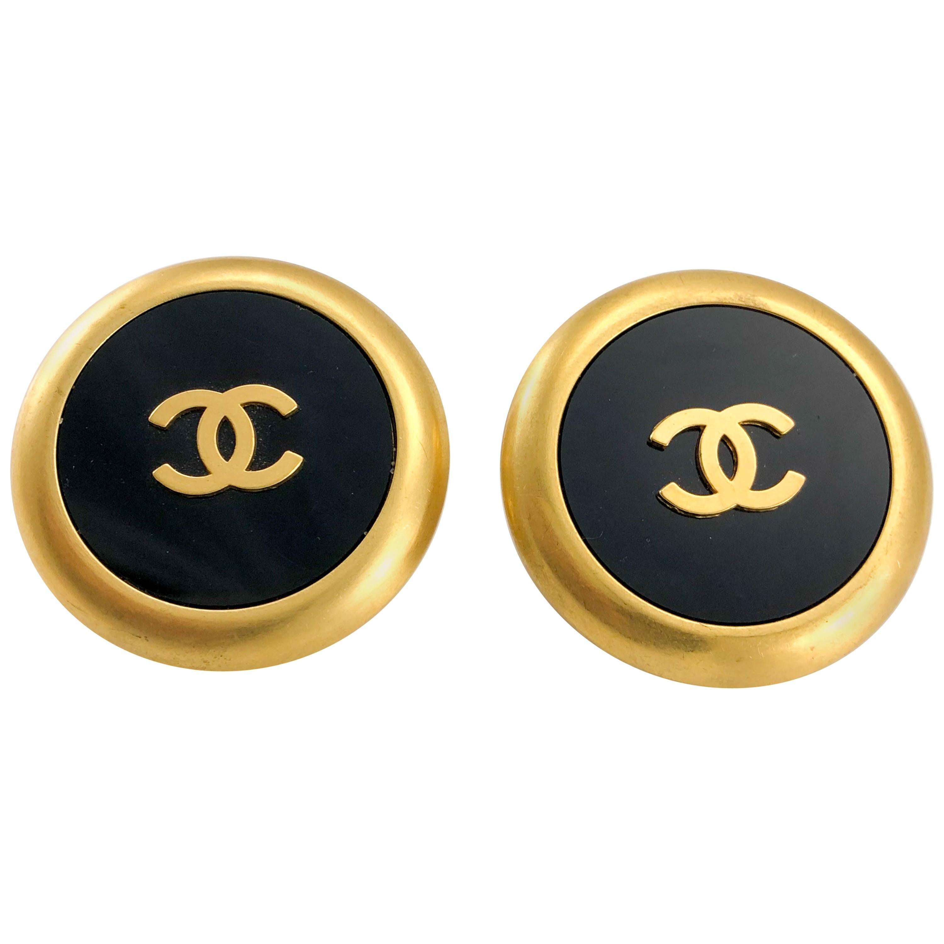 1992 Chanel Large Black And Golden Round Logo Earrings For Sale