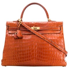 HERMES. 32cm Kelly bag in brown porosus crocodile, gold-…