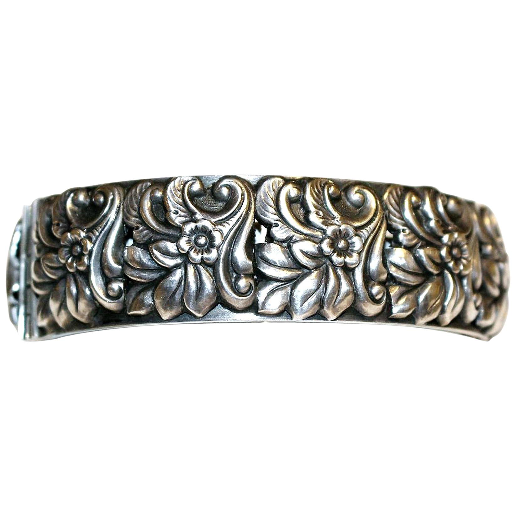 Circa 1950s Sterling Silver Floral Repoussé Hinged Bangle For Sale
