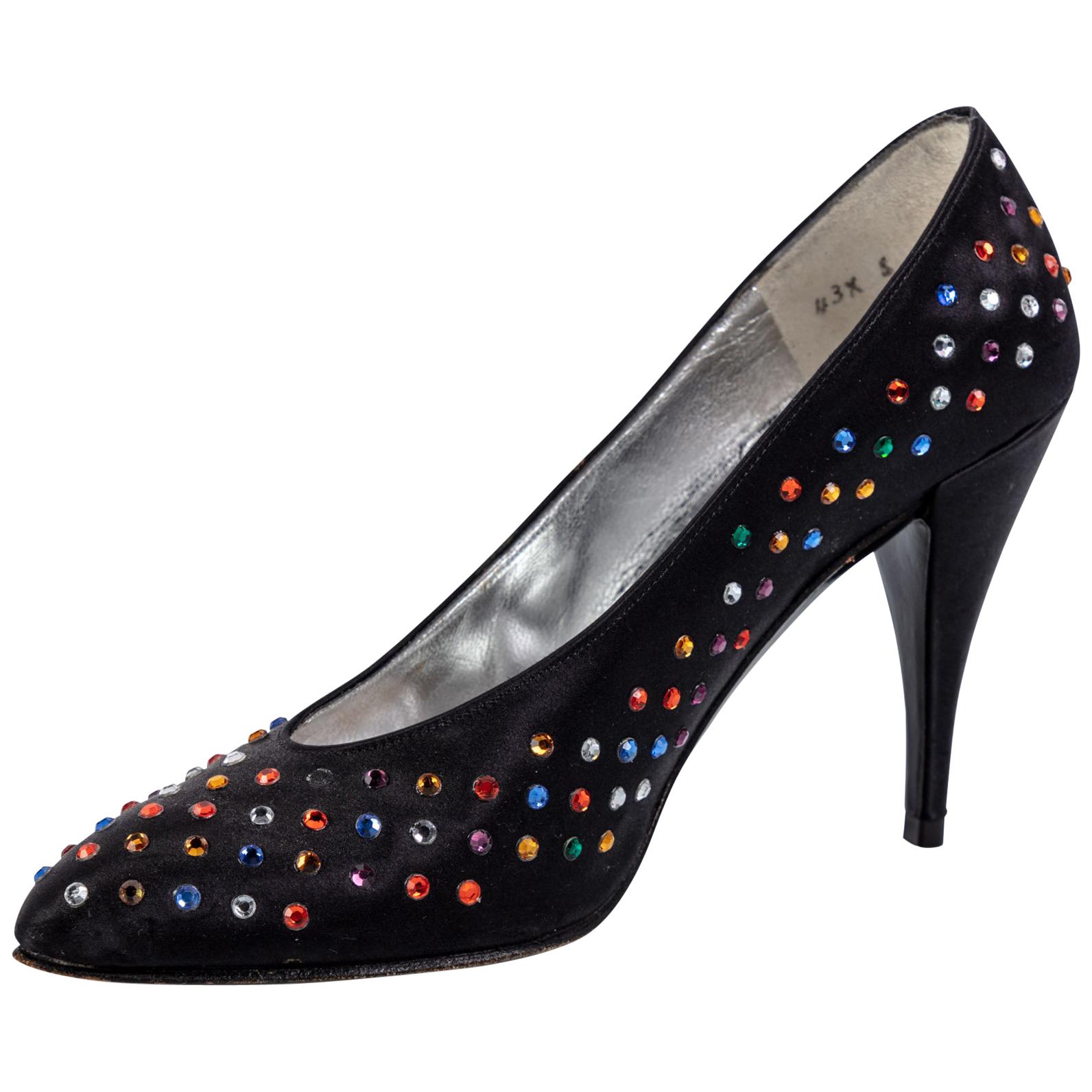 Vintage Charles Jourdan Paris black satin point toe high heel pumps. Leather soles.
Embellished with jewels in every color of the rainbow. Red, purple, yellow, ruby red, emerald green, blue, and diamond color.
Fits a size U.S 5 or a European 35
In