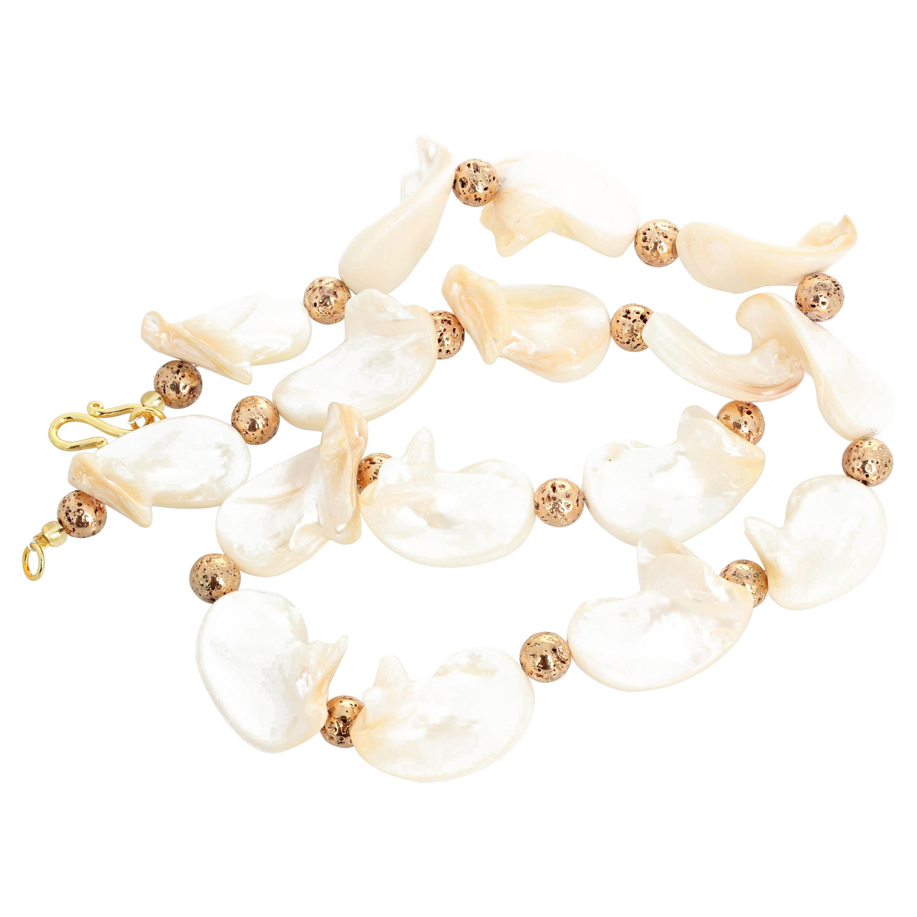 Dramatic beautifully glowing natural Shells accented with gold plated round natural Lava enhance each other elegantly in this 23 inch long necklace with a gold plated hook clasp.  