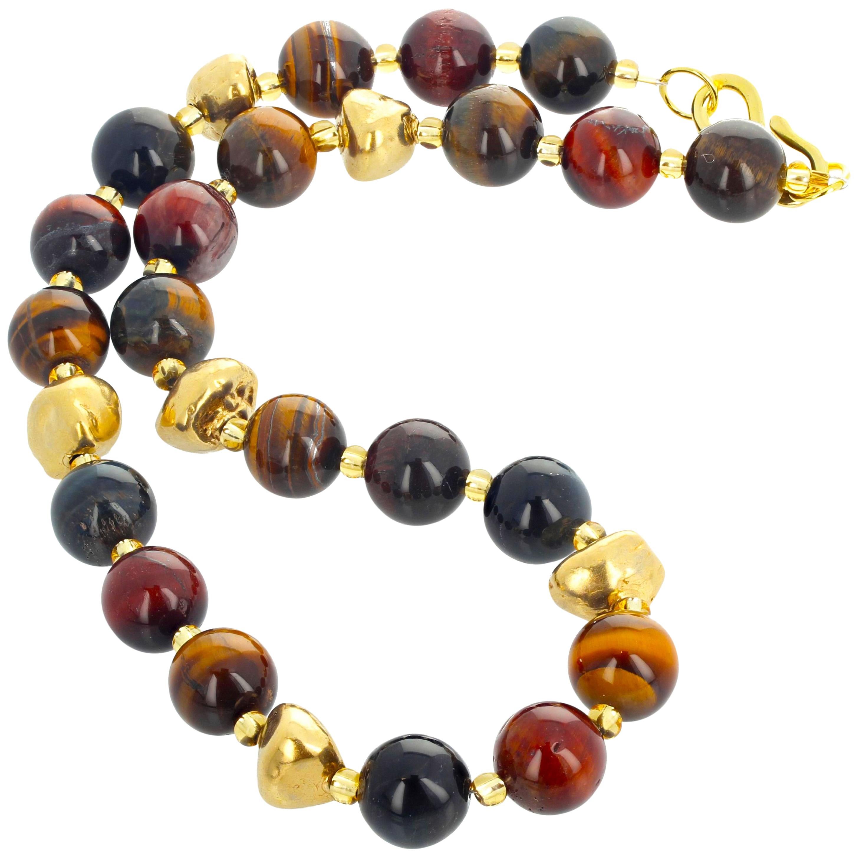 Glowing natural highly polished Tiger eye gemstones enhanced with gold plated nuggets and accented with brilliant crystals set in a 19 inch long necklace with gold plated clasp. The Tiger Eye are approximately 12mm.  