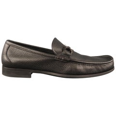 Used SALVATORE FERRAGAMO Loafers Shoes comes in a black tone in a pebble grain leathe