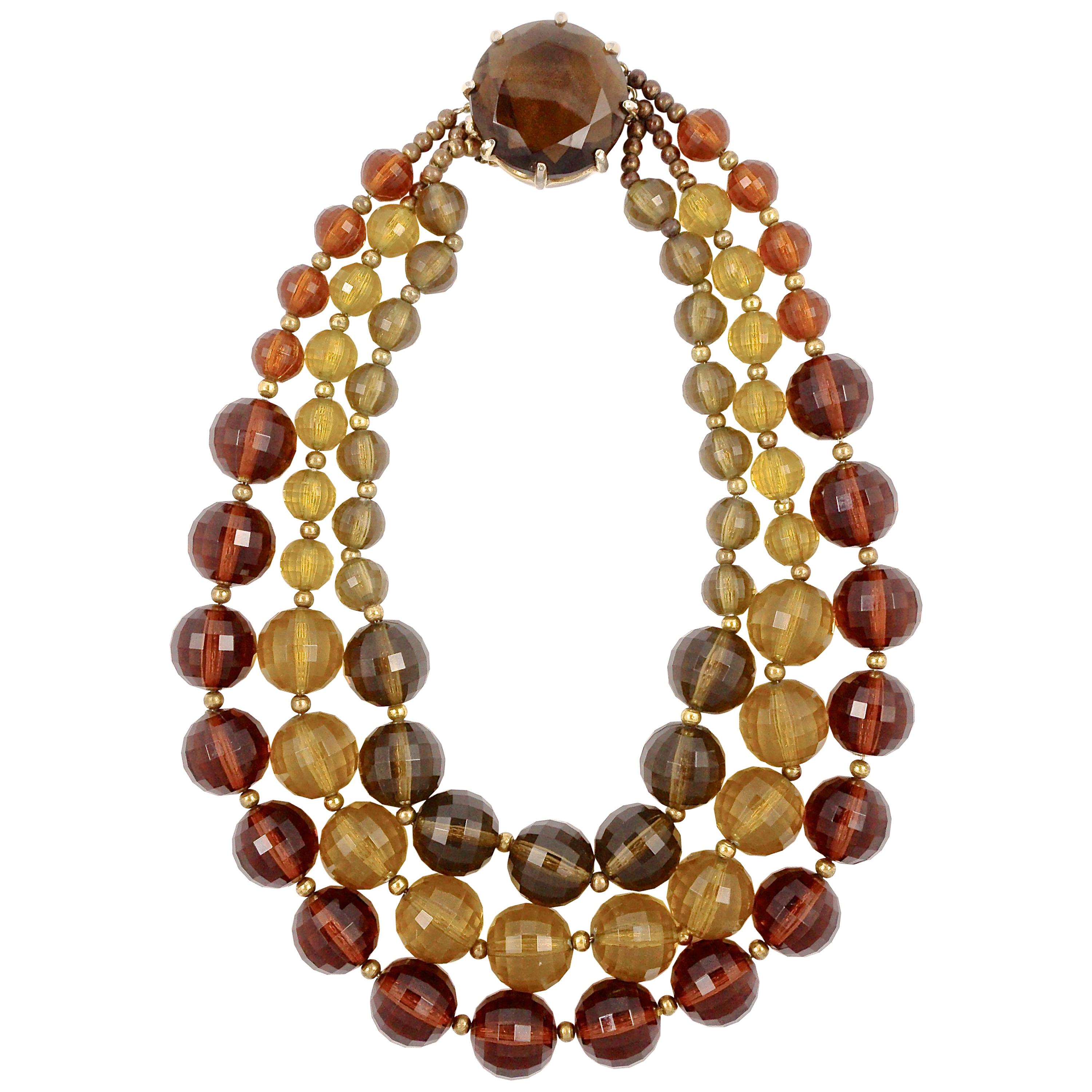 Gold Plated Triple Strand Multi Colored Plastic Bead Necklace with a Glass Clasp