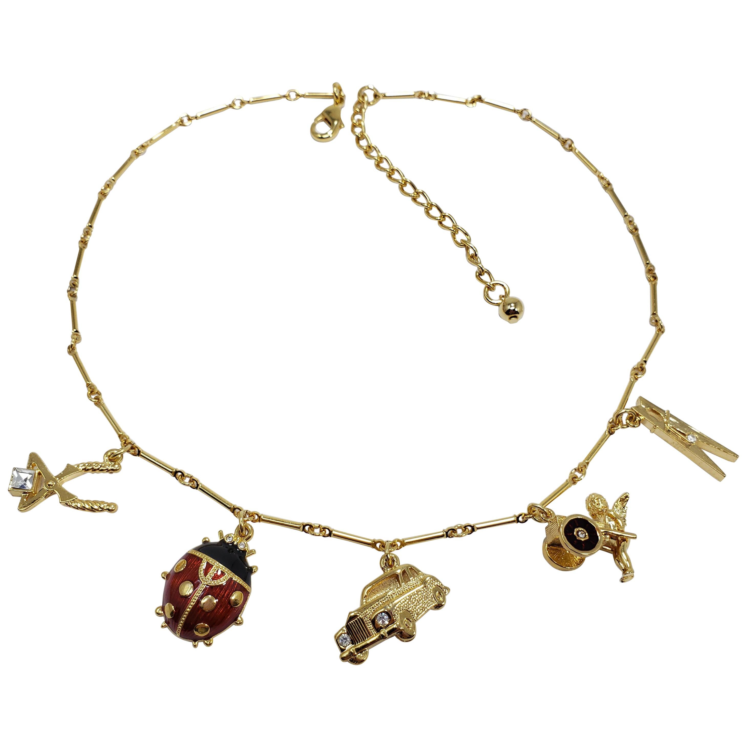 Kenneth Jay Lane Bar Link Charm Necklace in Gold, features Ladybug, Car, Angel