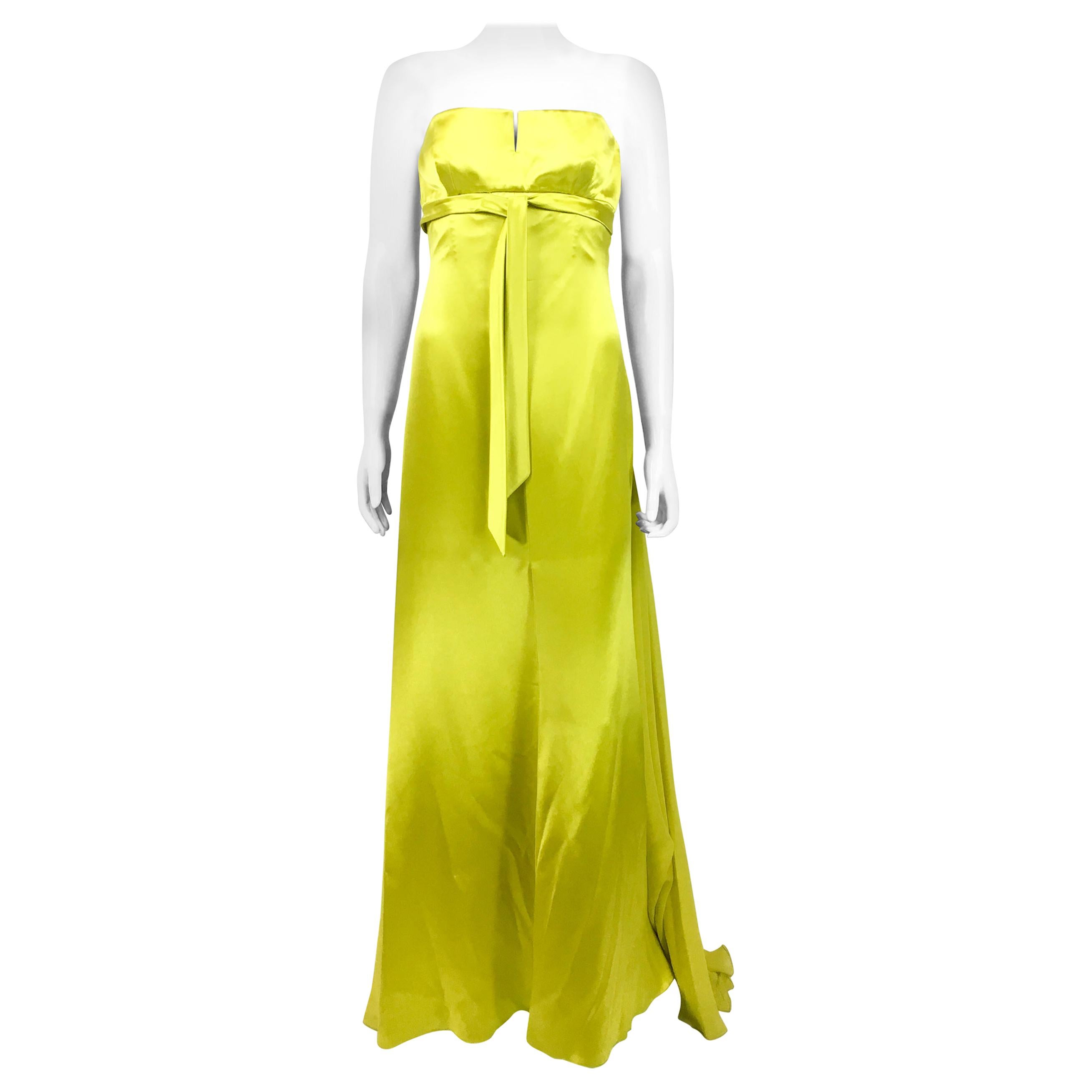 Vintage Valentino Chartreuse Silk Evening Gown. This fabulous strapless gown by Valentino dates back from the 1990’s. With a bustier design and empire waist (high waist), it has boning structure to accentuate the waist. The front of the dress is