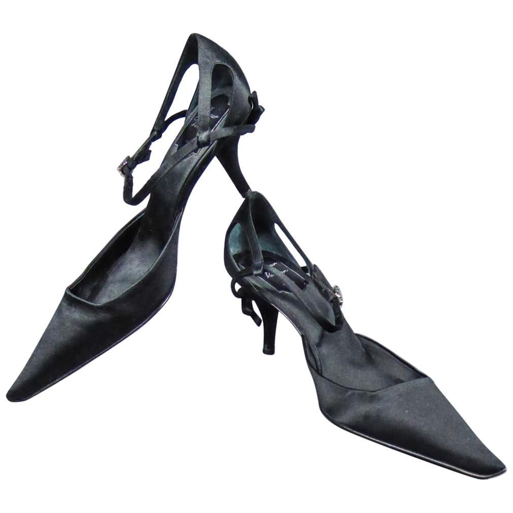 Circa 2000
France
Pair of evening pumps as new by Roger Vivier in black silk satin dating from the year 2000. Shoes with stiletto heel with pointed shape in front, decorated with a bow in the same fabric on the heel. Closes by a strap with a