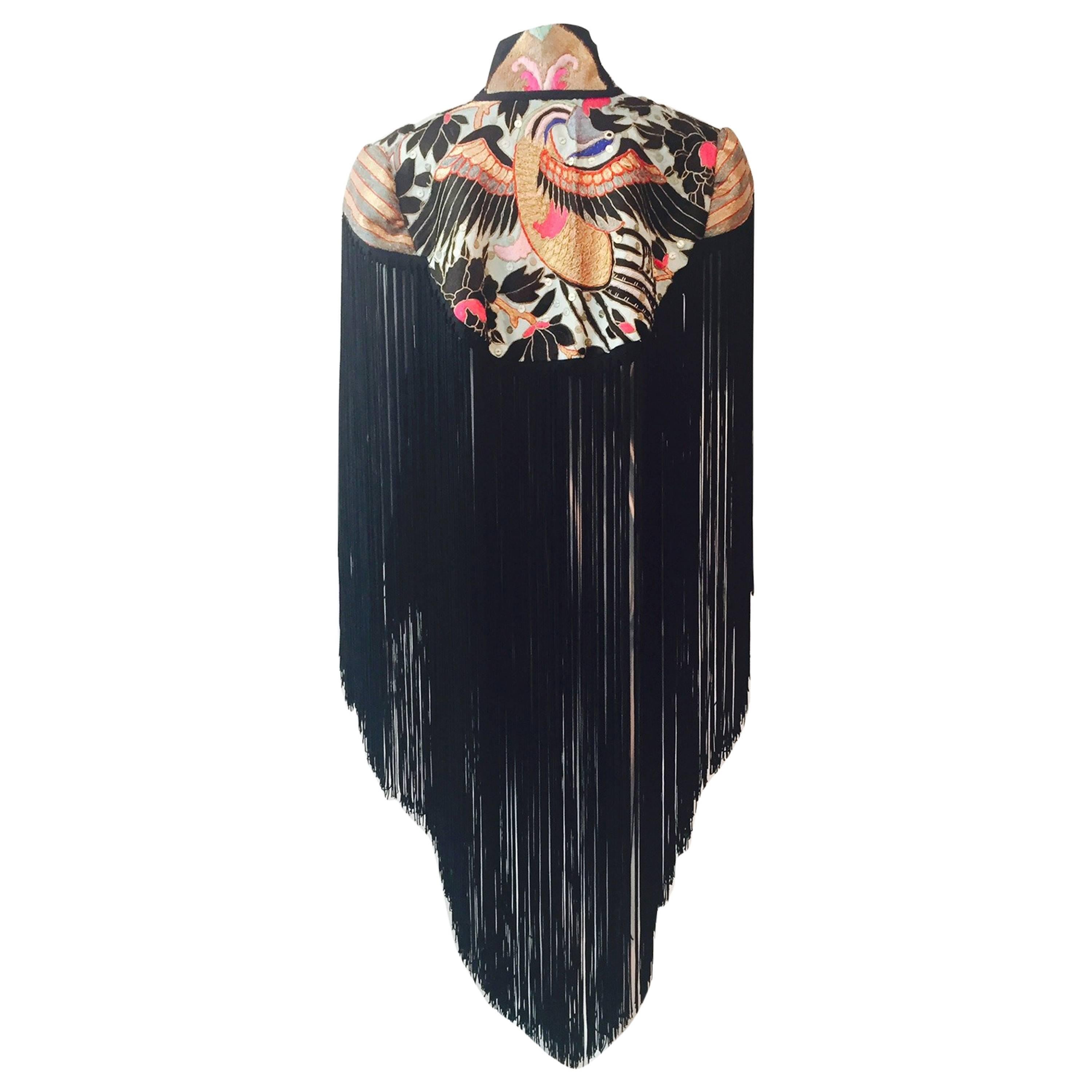 A gorgeous, and unusual Victorian-styled caplet, edged in long, hand-tied rayon fringe and heavily embroidered in vintage Chinese fabric. Mandarin collar and frog closure.  Floral silk lining fabric.