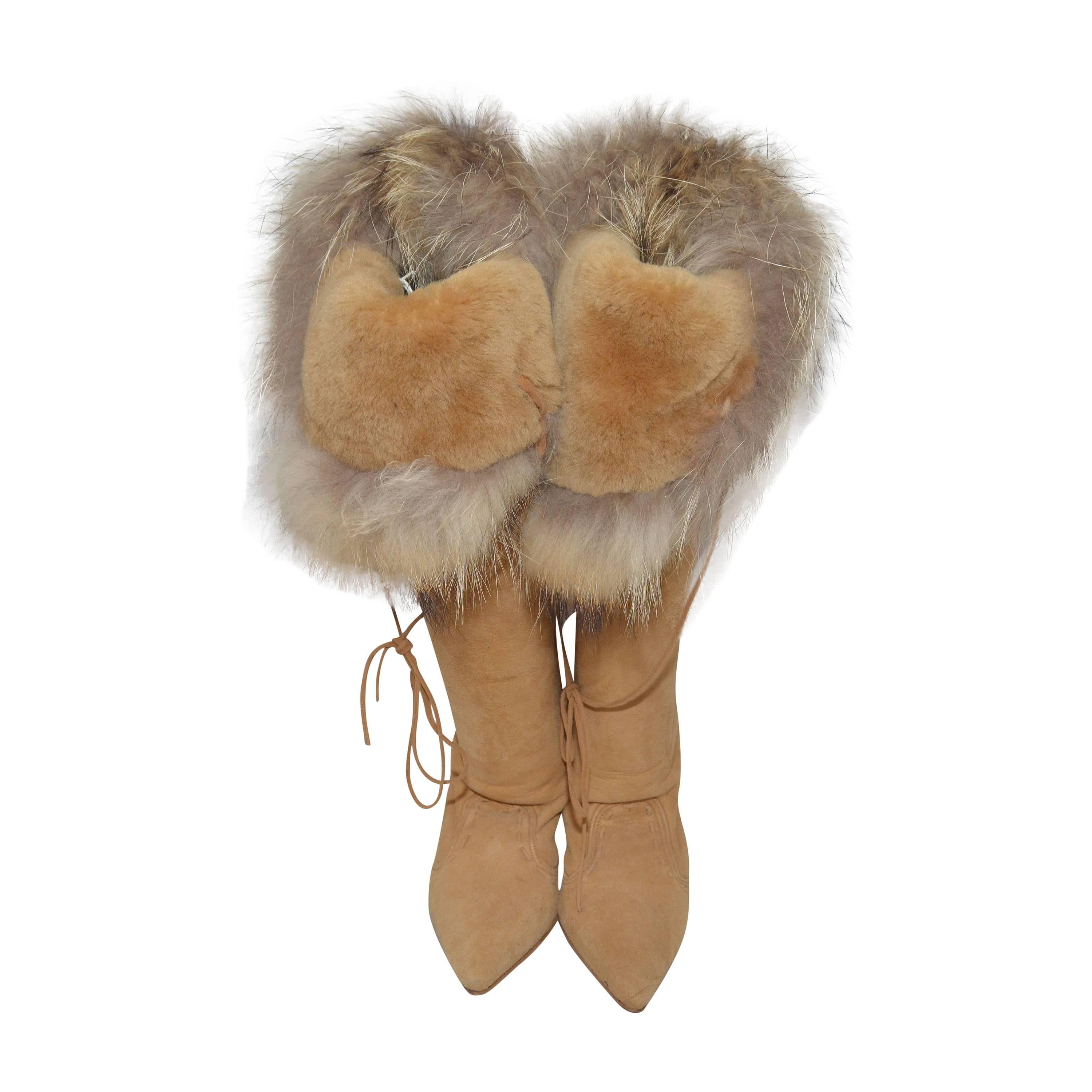 Manolo Blahnik boots have a shearling lining and Fox trim at top of boot, fully lined, and a wood-stacked heel. Can be worn folded down or over the knee. Heels measure approximately 3 inches. Floor to front top of the boots is 21