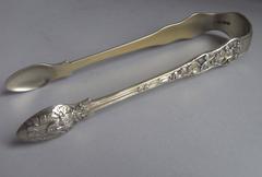 A rare pair of cast Silver Gilt Bacchanalian Pattern Tongs, by Theobalds & Atkin