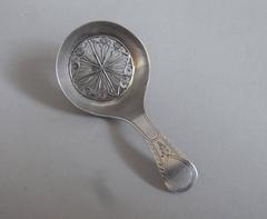 A rare George III "Spider's Web" Bowl Caddy Spoon by Thomas Willmore.