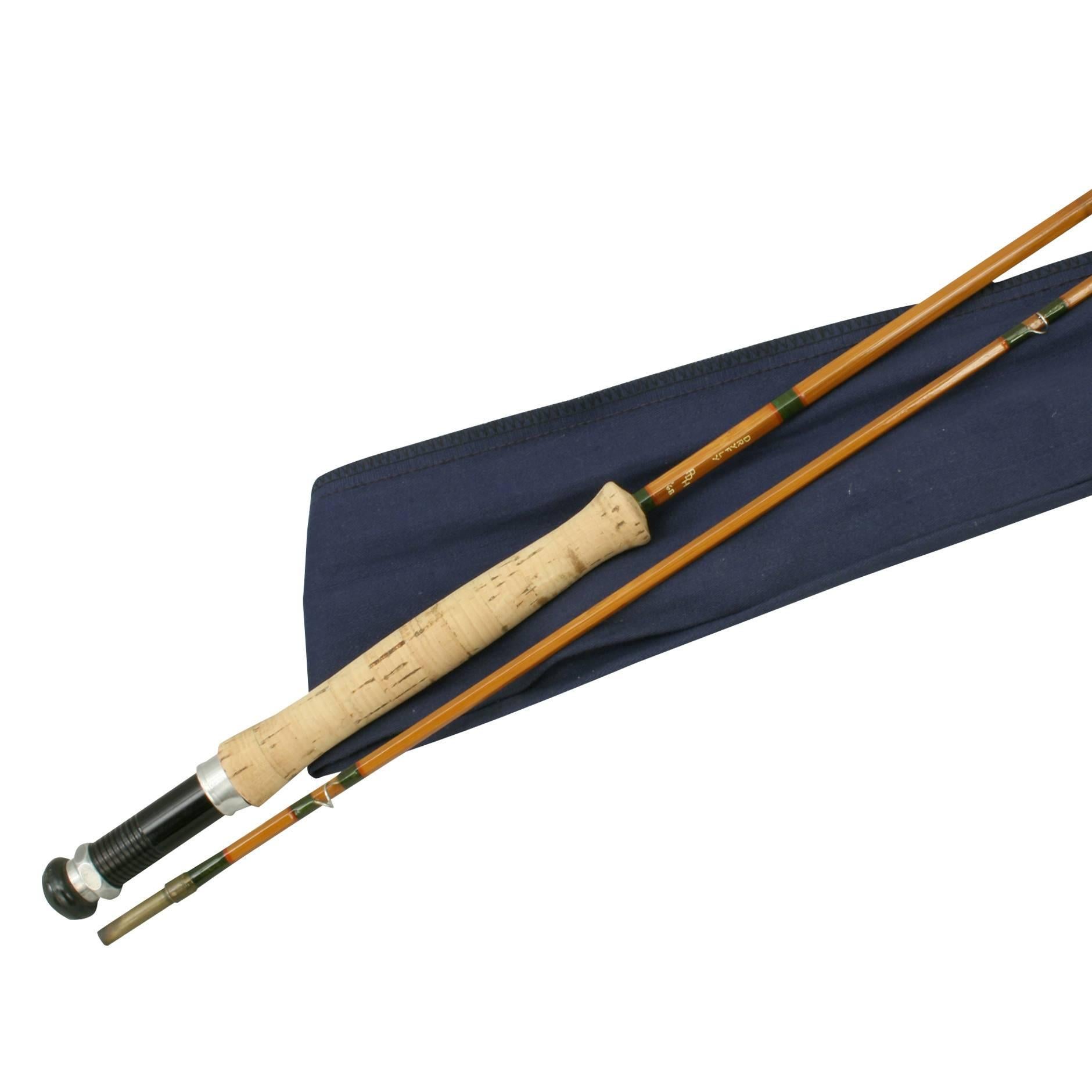 A split cane two-piece trout fly fishing rod in excellent original condition with blue canvas bag. It has the inscription on the rod, DRY FLY PDH '68. A stunning 8.7 foot; long rod with suction joint, rubber butt, alloy screw reel fitting, smooth