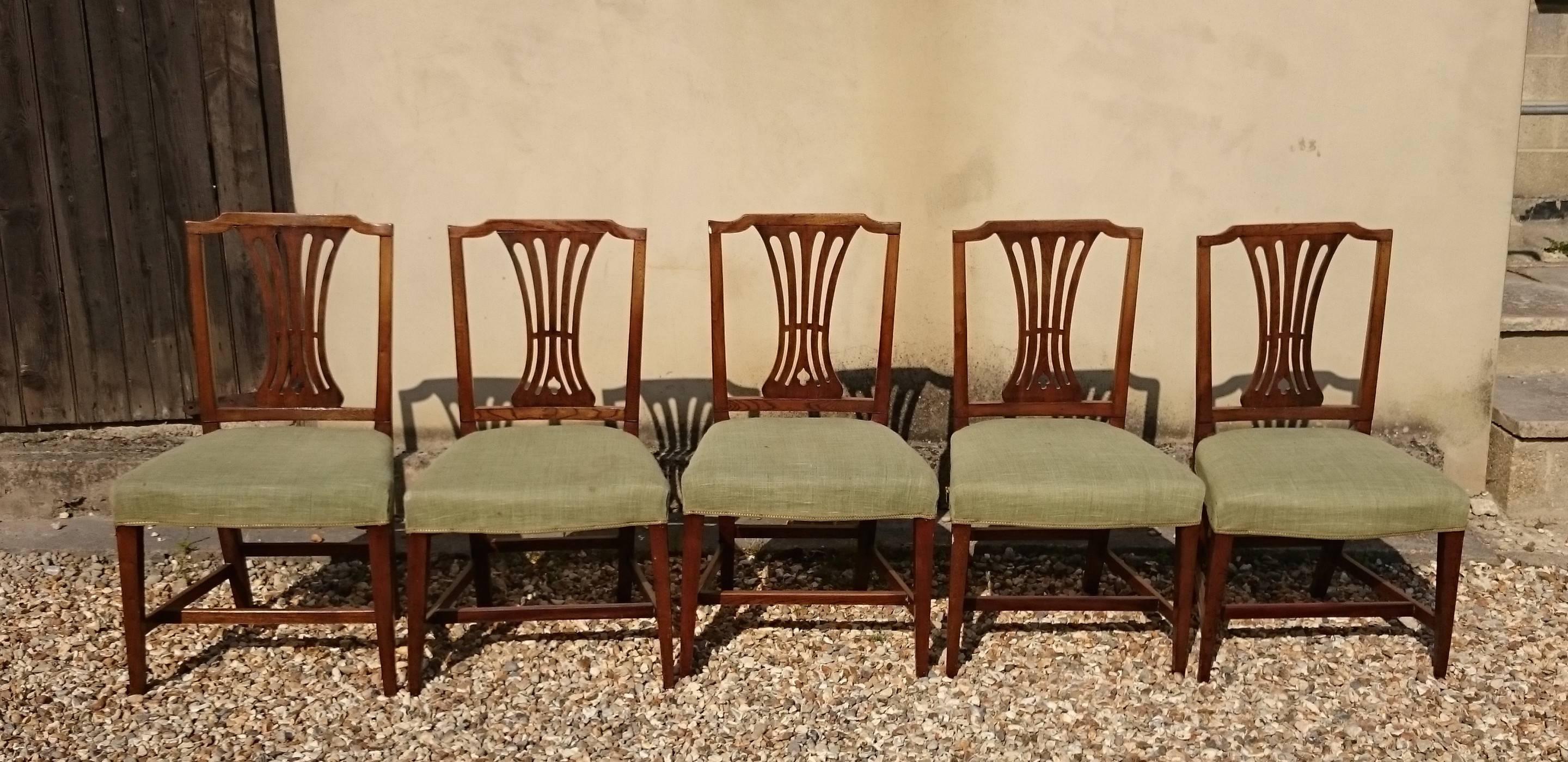 Set of five antique elm dining chairs with drop in seats. Elm is one of the most sought after indigenous timbers used for vernacular furniture and it is always a treat to see it used in period fashion furniture. With green seats, 

English, circa