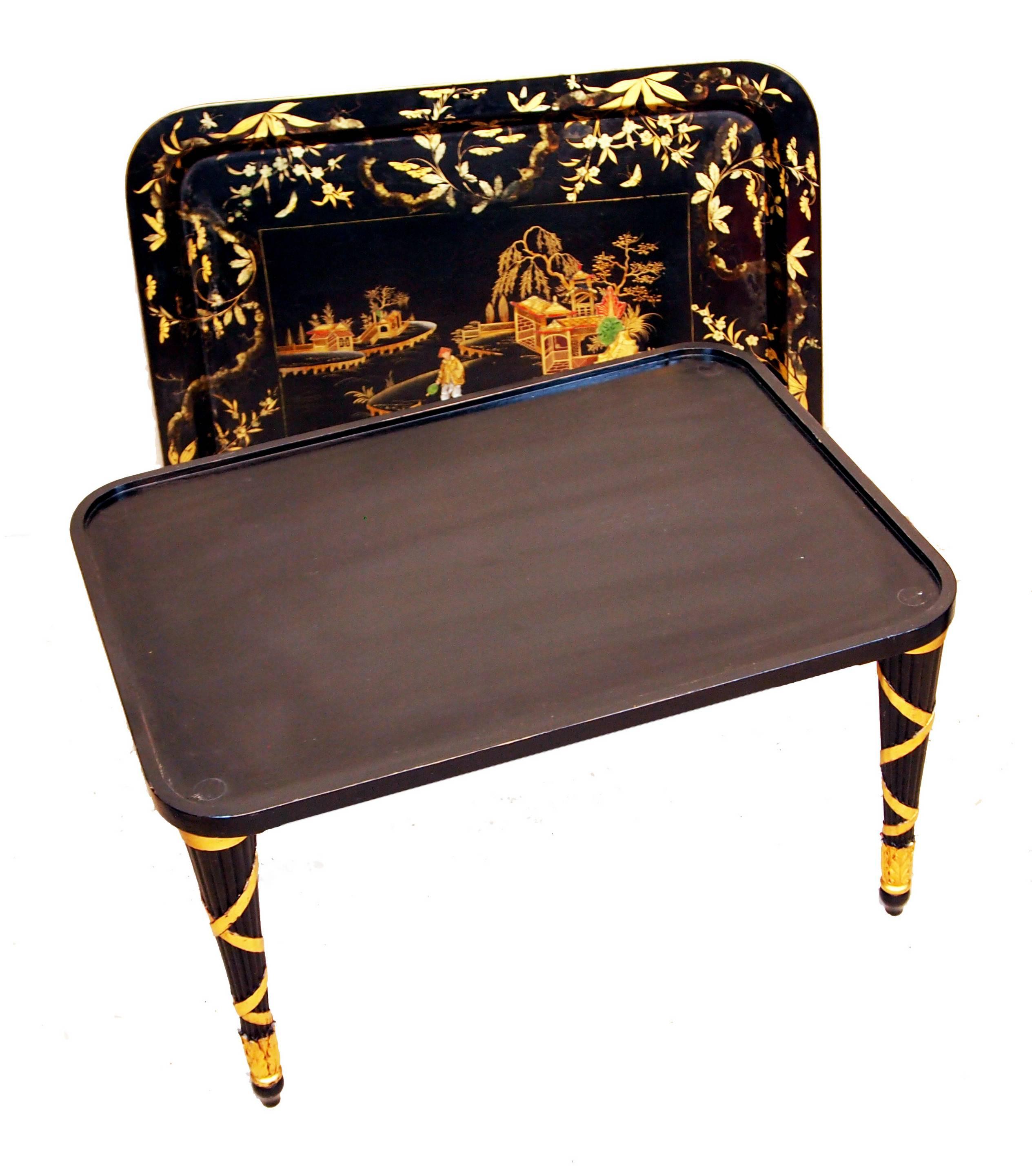 A Very Attractive Mid 19th Century Papier Mache Tray Having 
Delightful Painted And Gilded Decoration Housed On Later Ebonised
And Gilded Turned Tapering Leg Stand

(Often originally made in sets of three that varied in size paper mâché 
trays