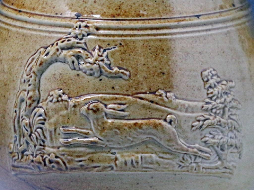 A good stoneware saltglaze pottery coffee pot with applied sprigs of a running hare and a pheasant in naturalistic settings. The piece is of exceptional quality with fine attention to detail.