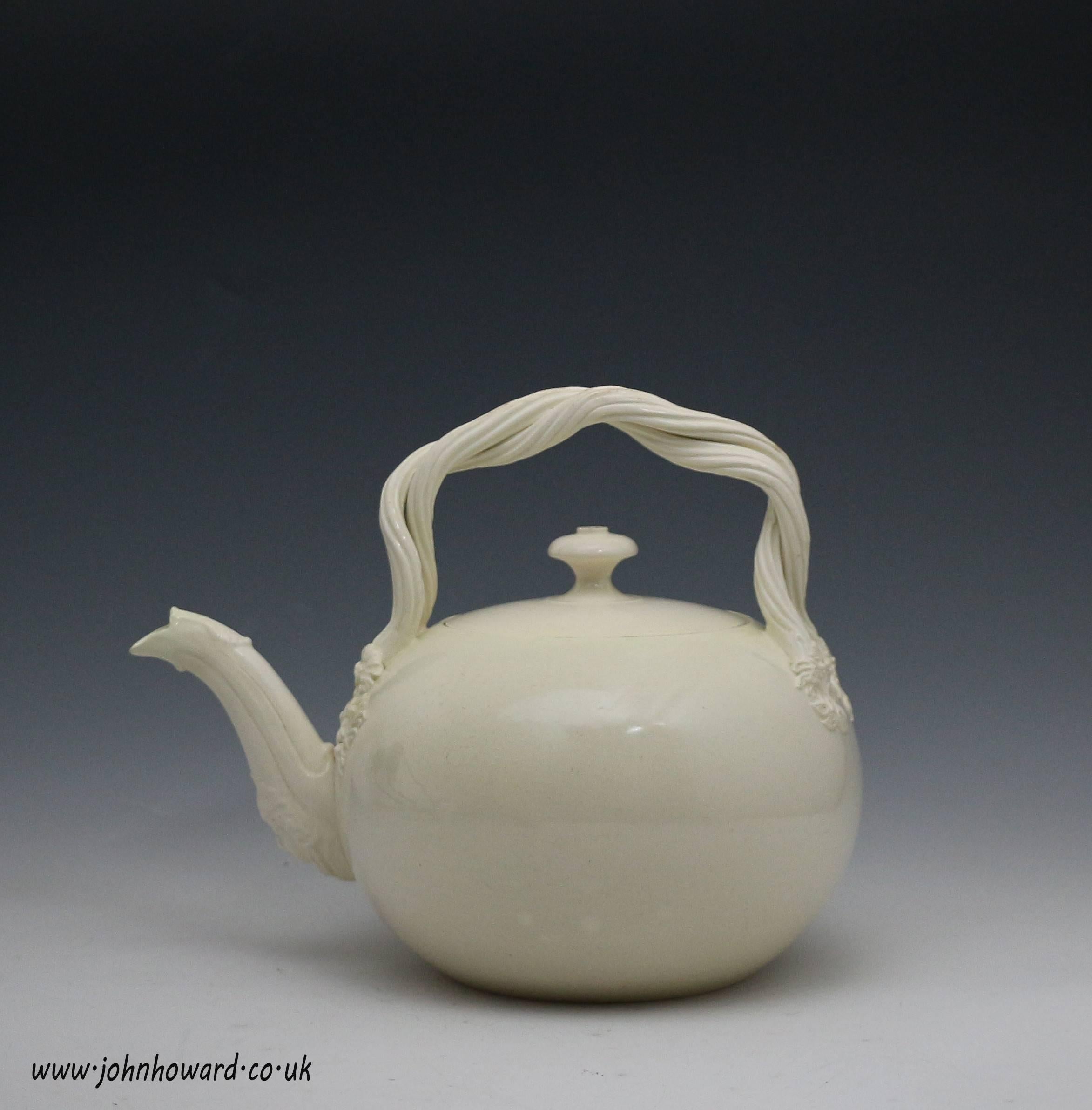 A fine quality late 18th century plain creamware silver shaped punch pot or tea kettle. 
Rope twist handles, a female head and florette finials add touches of elegance to this quality and rare piece. 
Yorkshire Pottery.