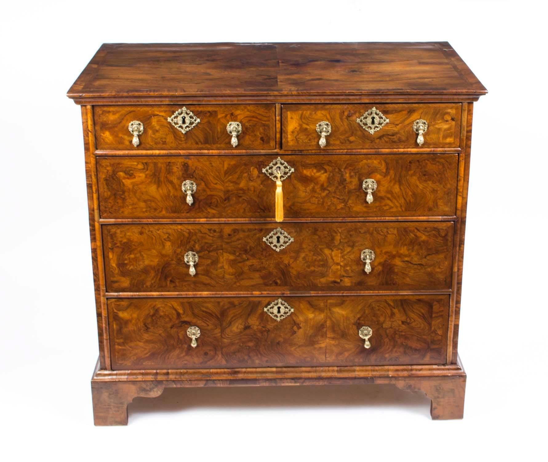 This is a stunning antique Queen Anne walnut chest of drawers, circa 1730 in date.

It has two short drawers above three full width drawers and they are all oak lined. The top and the drawer fronts have beautiful herringbone crossbanded decoration