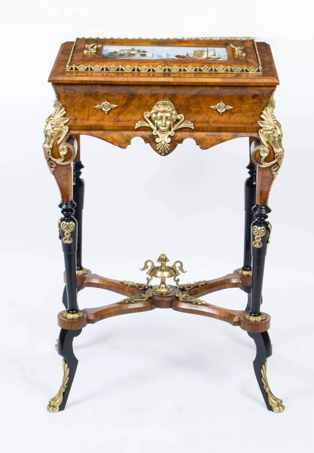 This is a superb antique Napoleon III porcelain and gilt ormolu mounted burr walnut and ebonised jardiniere after Charles Guillaume Diehl. 

The twin handled lid is inset with a beautiful hand painted Sevres style porcelain plaque decorated with