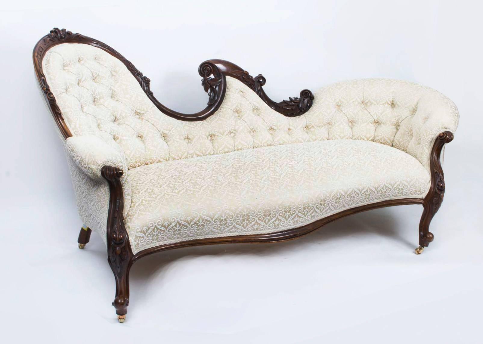 This is a fantastic pair of near identical English antique Victorian carved mahogany chaise longues facing opposite ends, circa 1870 in date. 

They are made from solid mahogany and stand on elegant carved cabriole legs which terminate in the
