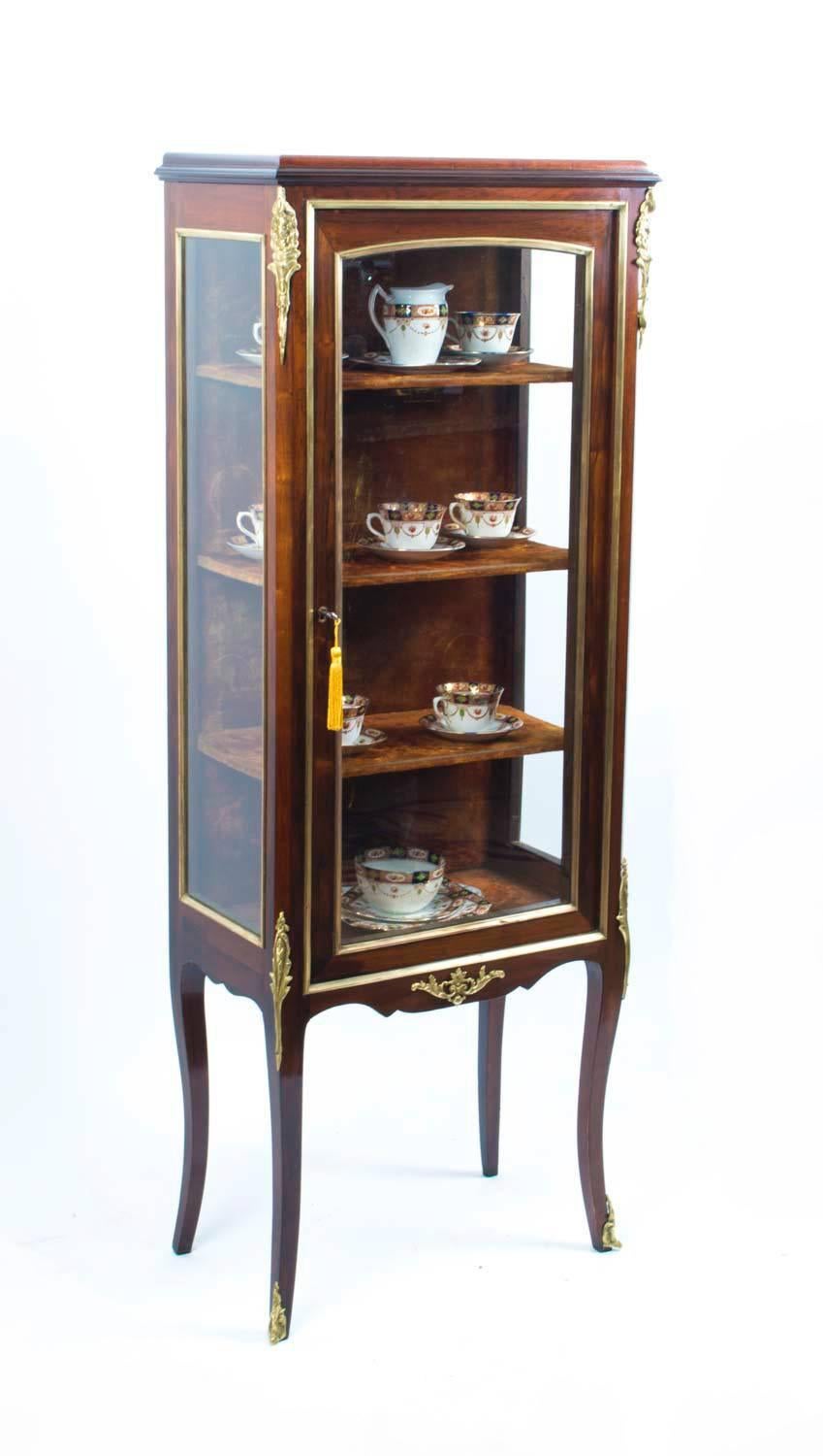 This is a beautiful antique French mahogany and ormolu mounted display cabinet in the French Louis XV manner, circa 1900 in date. 

This beautiful cabinet has an abundance of exquisite ormolu mounts. 

It has glass to the front and sides, the