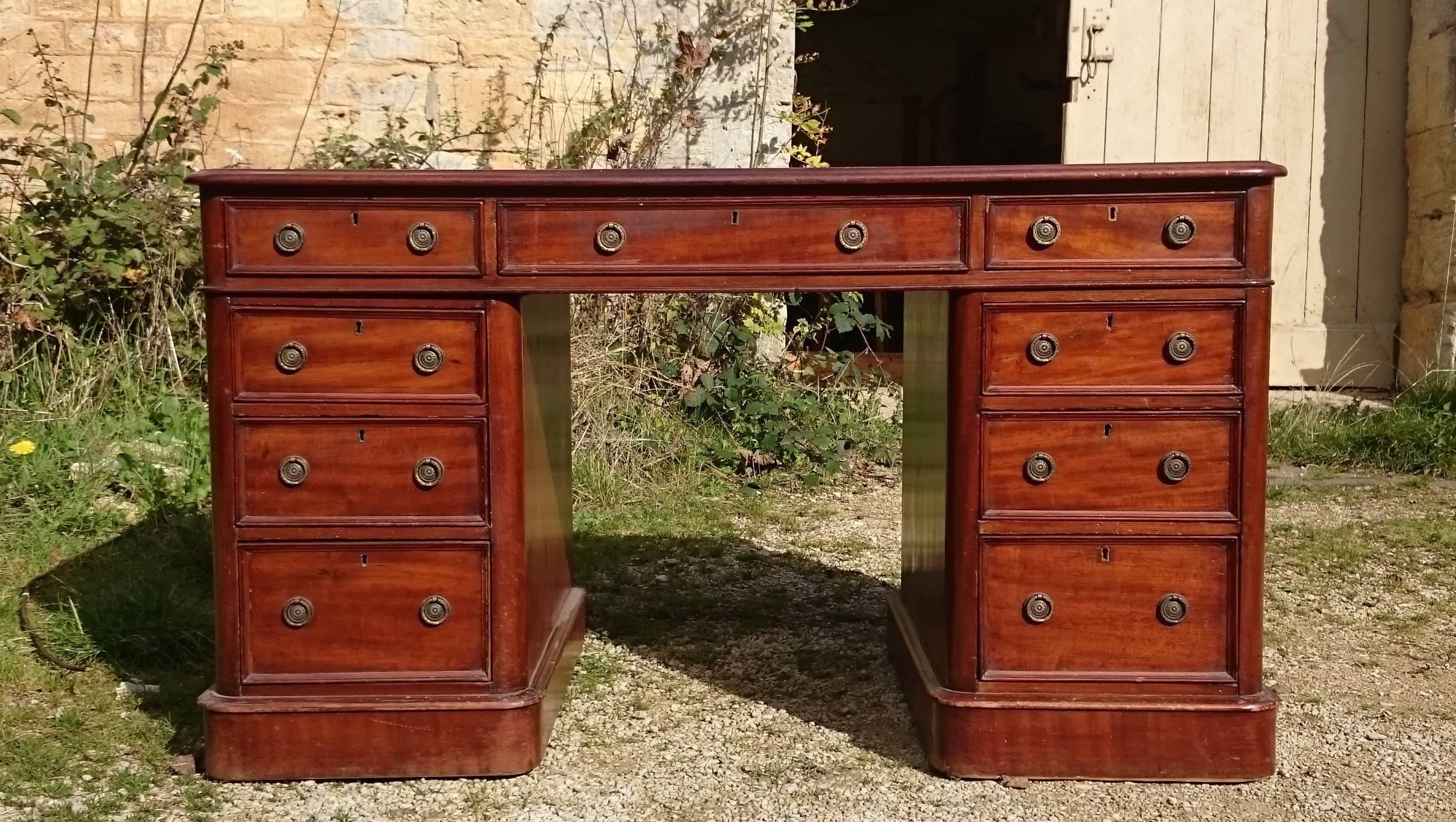 Antique desk made of good dense mahogany with interesting figuring in the grain. Drawers one side and finished on the reverse. 

English circa 1840 

29