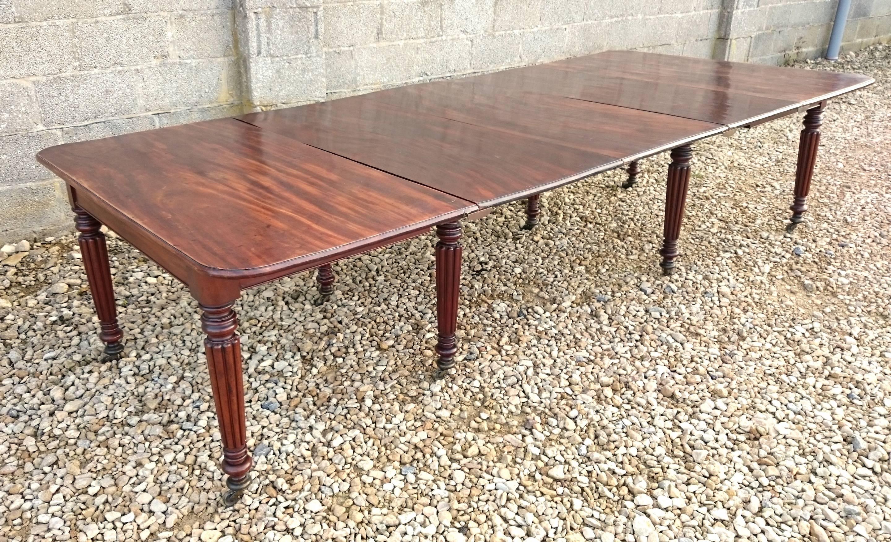 Regency mahogany antique dining table. This table is versatile with three removable leaves and a mechanism that unbolts to create two separate tables in case the dining room needs to be used for something else. The frieze is good and narrow for