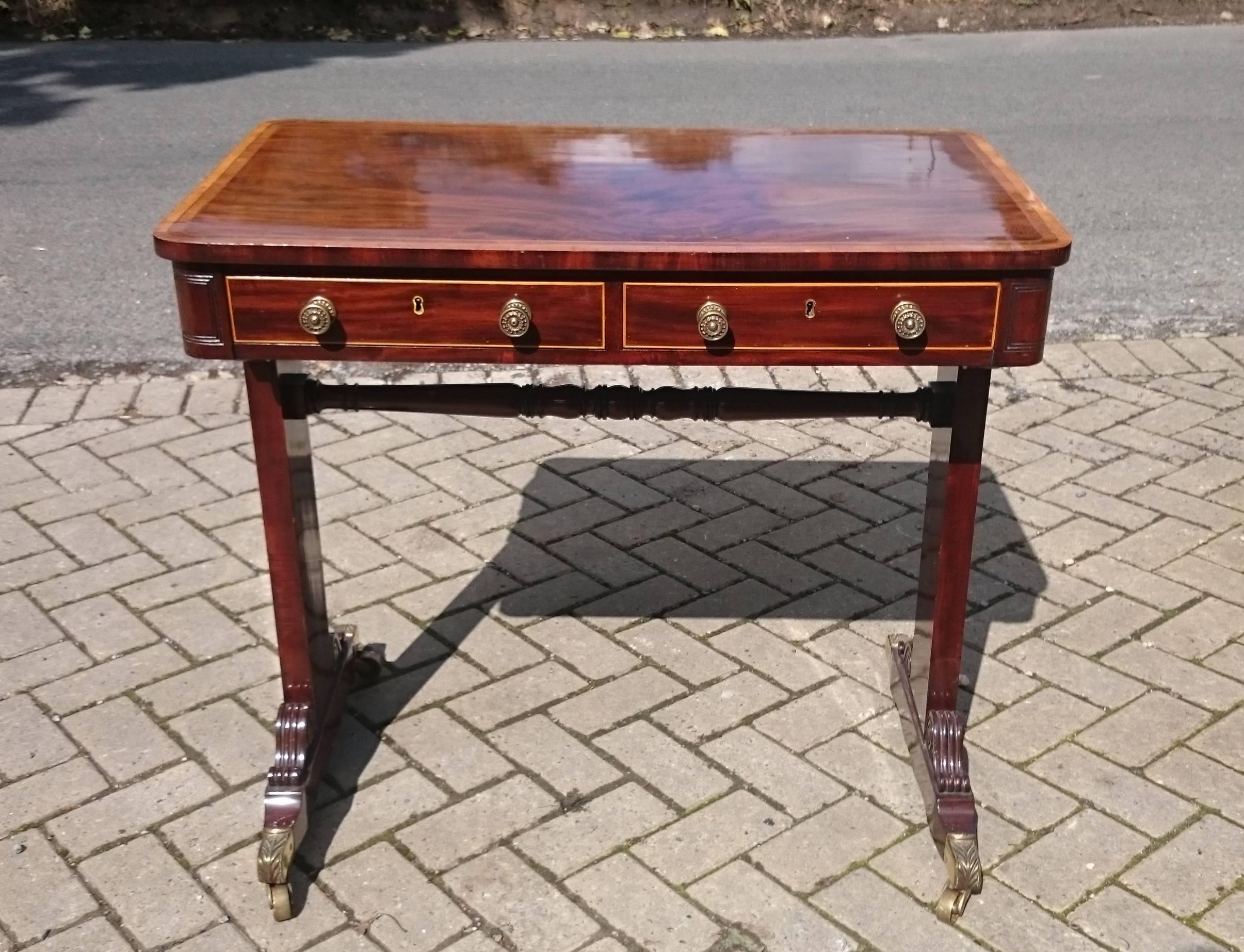 Regency mahogany centre table / writing table / lamp table, the rectangular top crossbanded in tulipwood and fruitwood, with two drawers in the frieze and the feet with scrolled reeded brackets. 

English circa 1810 
Provenance: Sold and valued