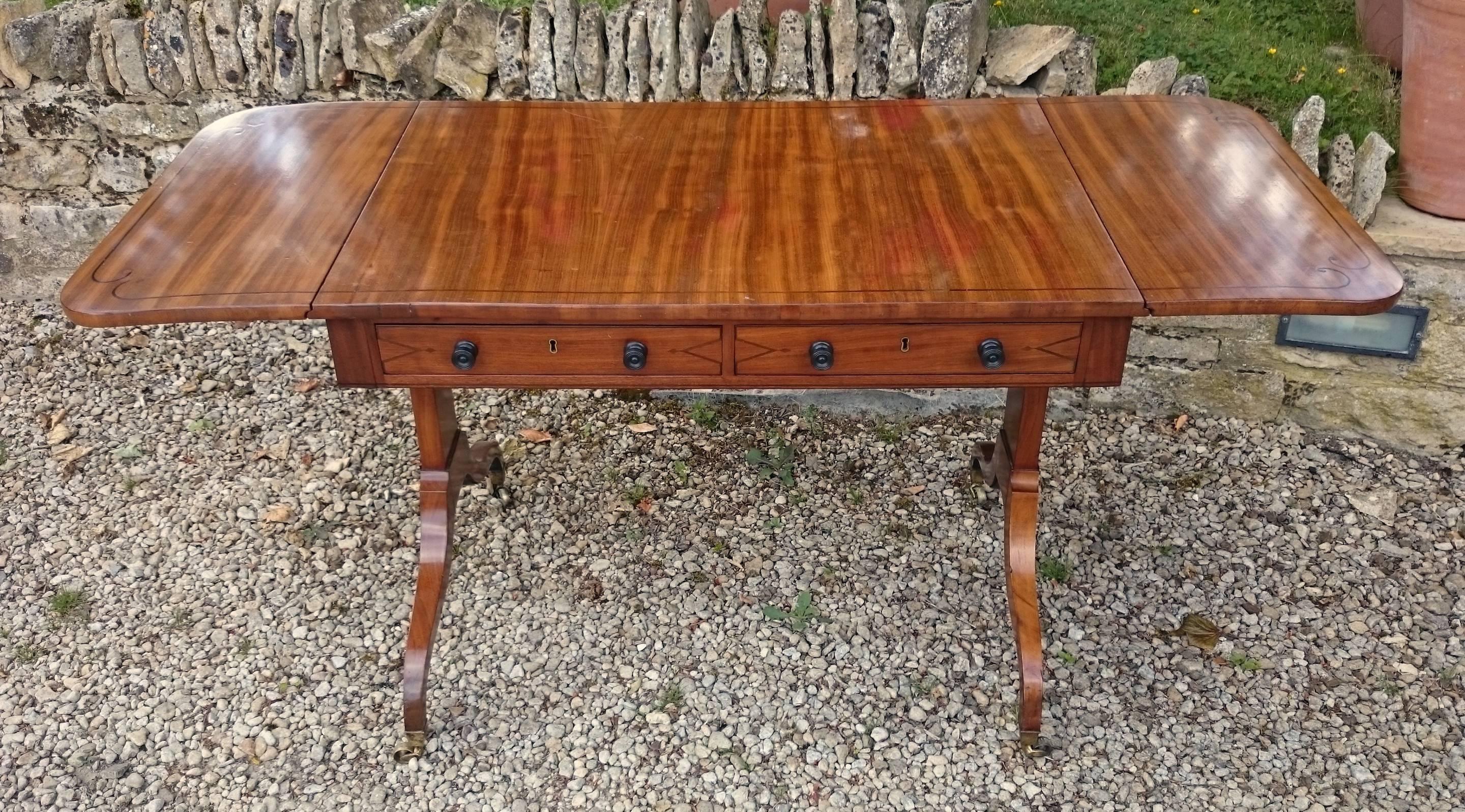 Antique sofa table made out of well figured mahogany which has attained a great colour and patination over the last two hundred years. This table is narrow front to back which makes it perfect for behind the sofa and also would work very well as a