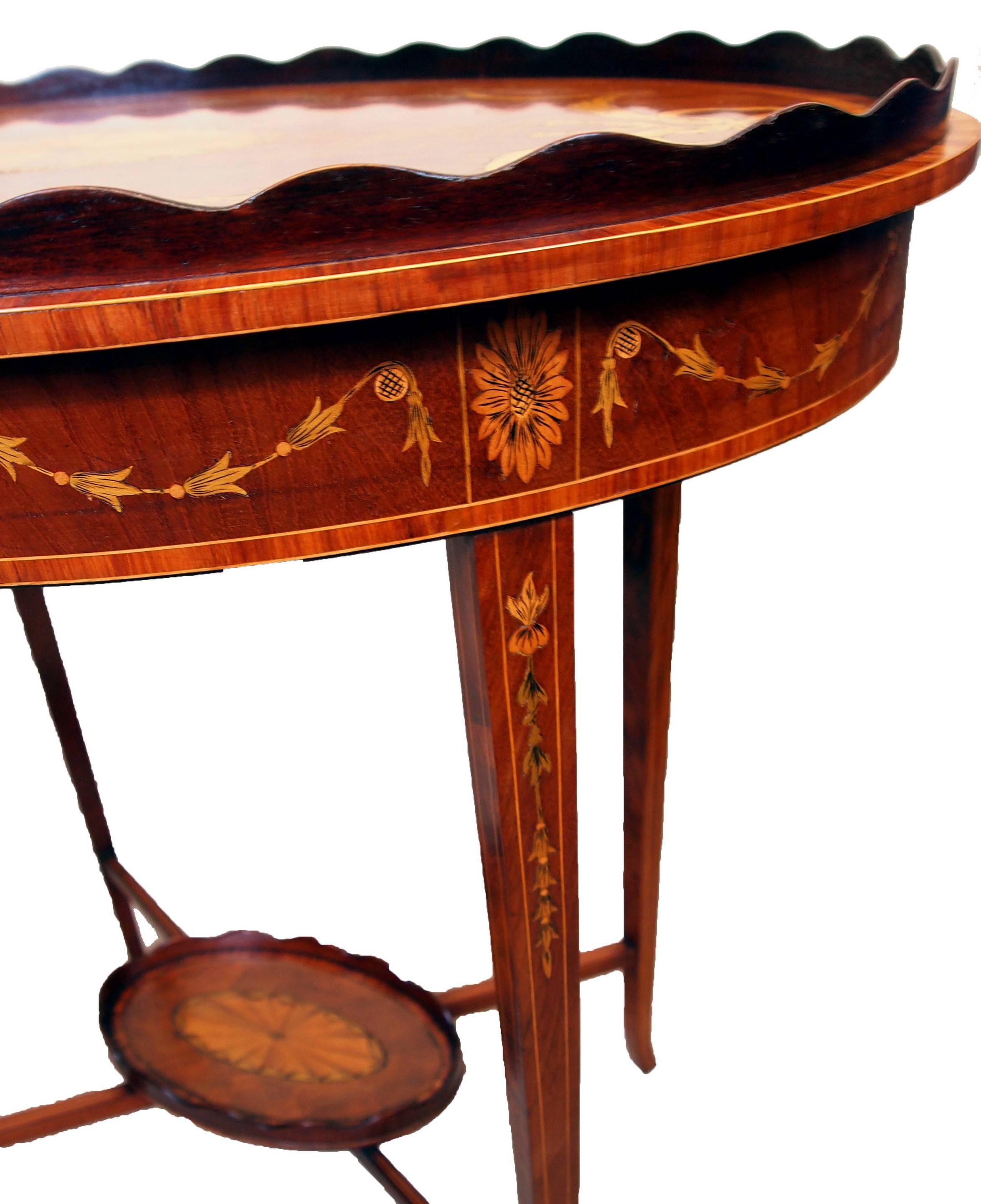 A fine quality late 19th century mahogany oval occasional table
having superbly figured oval top with superb inlay decoration and
wavy gallery raised on elegant square tapering legs united by
cross stretcher and under tier.