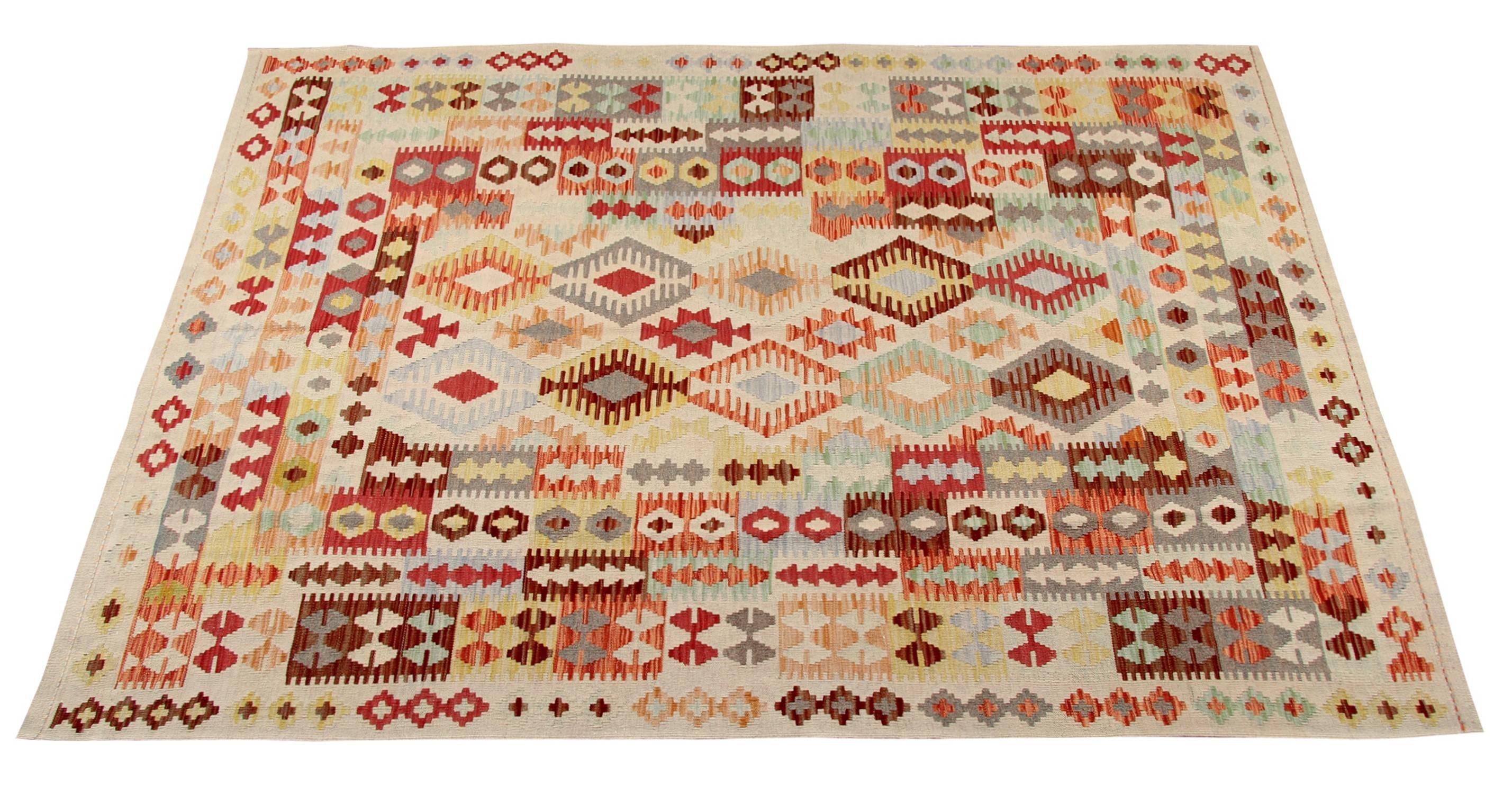 The Kilim shown is iconically called 'Mexican fiesta' (literally 'Mexican party') due to the variated colors on a cream background. The red, light blue, orange, yellow and green colors render this carpet particularly alive. The Kilim rug is