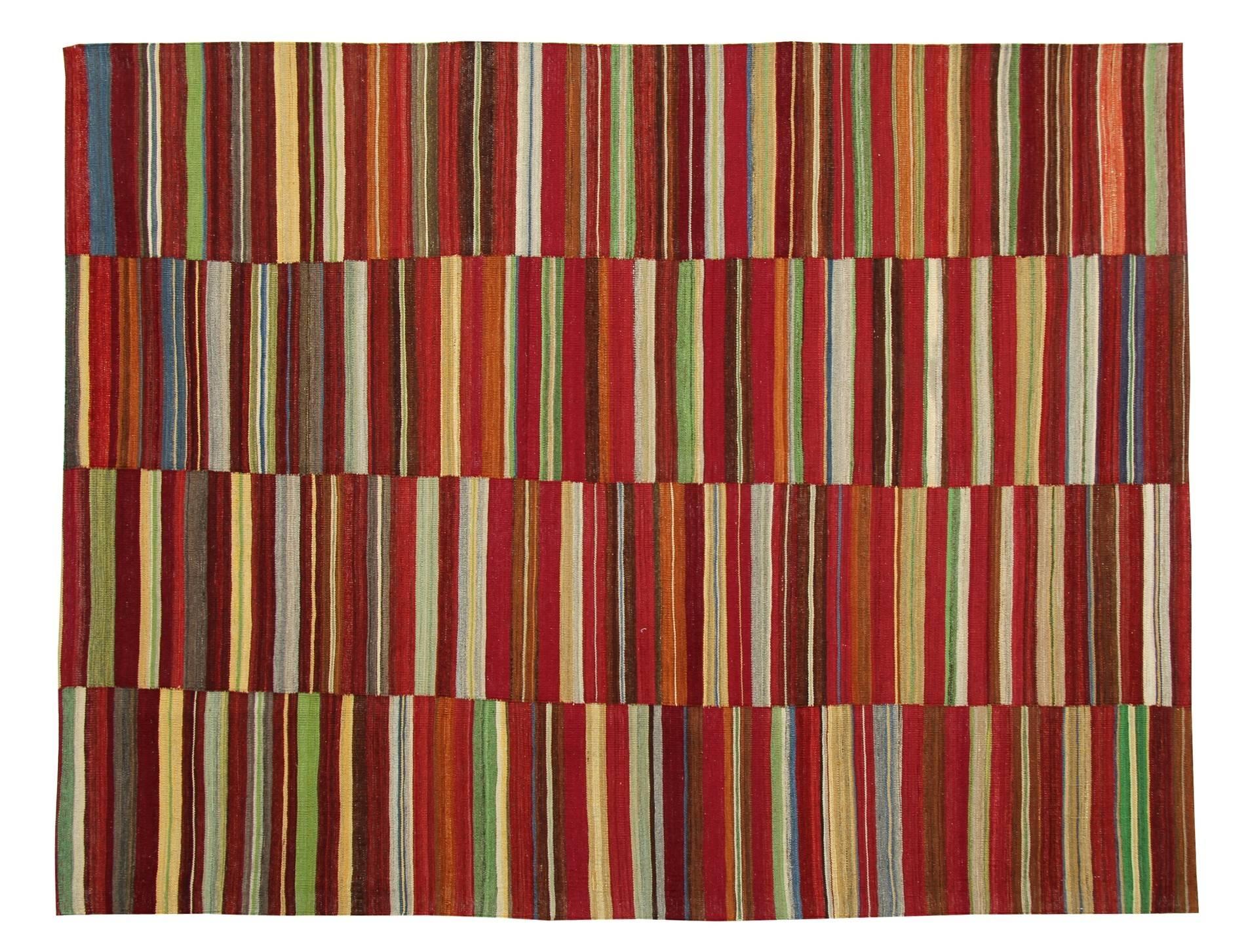 The red rug is bold and joyful, a striped rug makes a statement in any room. The tribal rug is very colourful yet organised, the stripes are symmetrical and in similar size and the clever alternance of colors makes it extremely appealing. The
