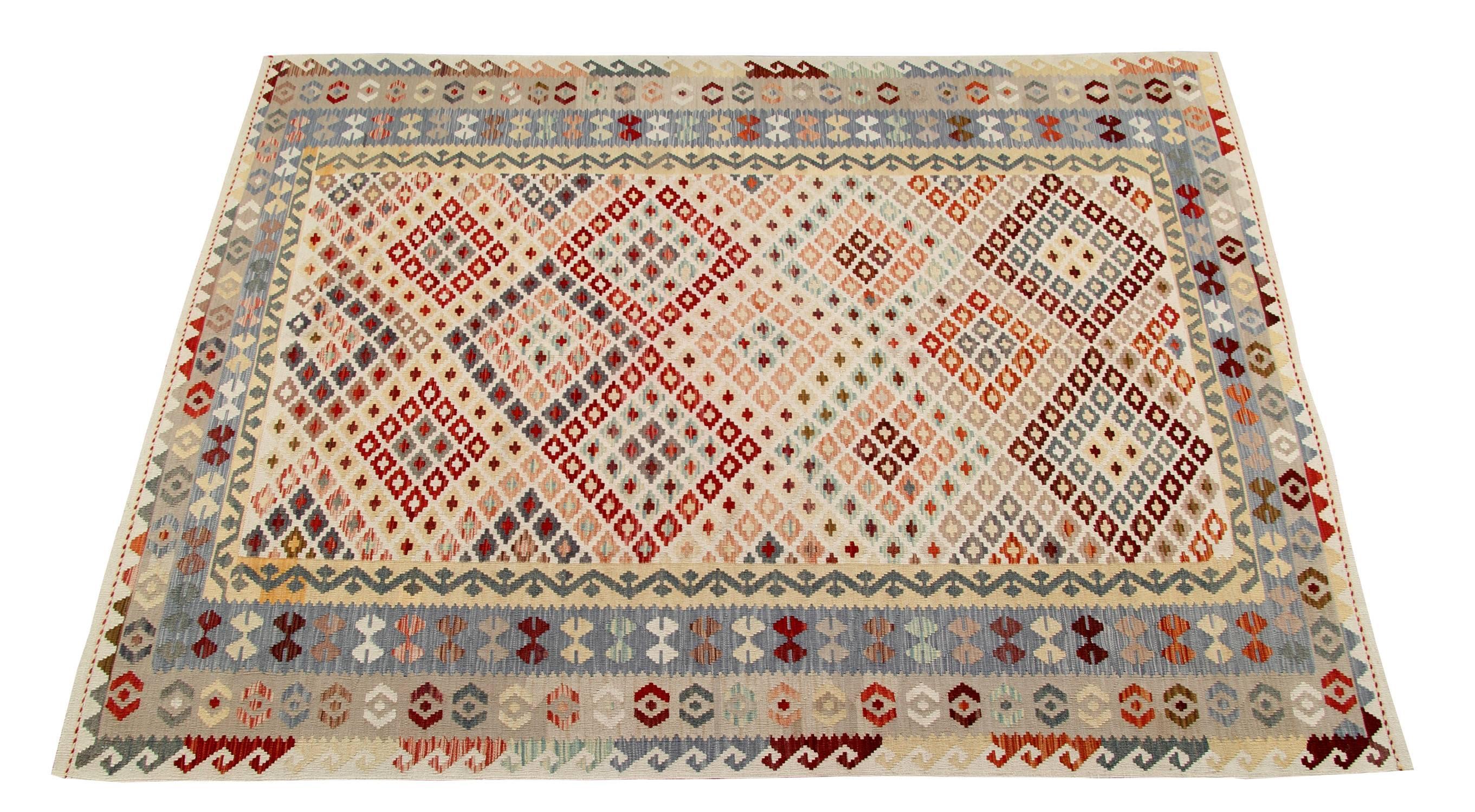 This tribal rug brings you into the realm of dreams. This geometric rug is in fact composed of very soft and delicate colours. The outside frame of this carpet rug is mainly in slate grey, whilst the central part of this carpet is constellated by
