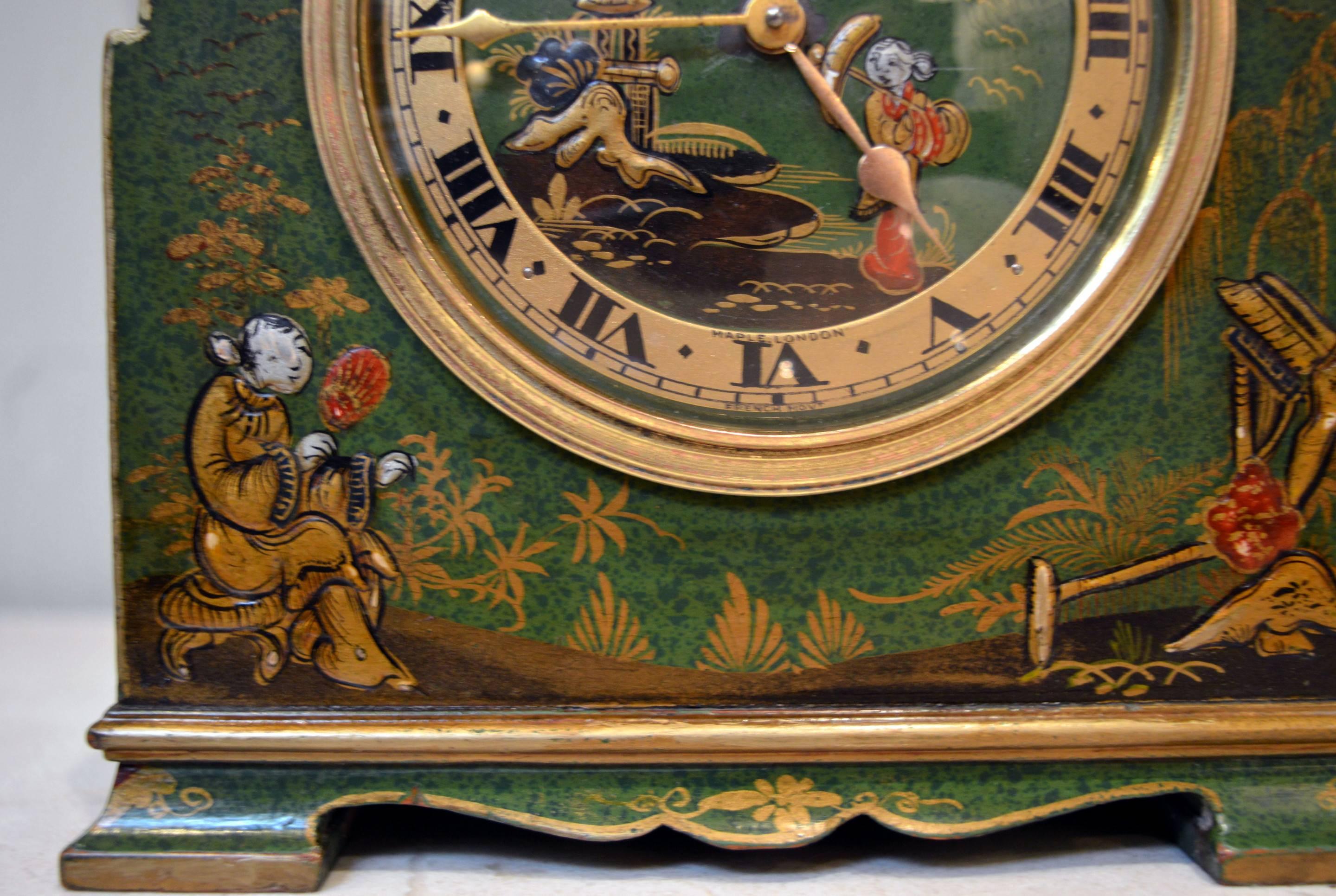 A very unusual Chinoiserie mantel clock. It has a arch top case, with a mottled green ground case with applied Chinese style raised decoration in gilt . The dial has a convex glass and a gilt chapter ring with a matching decorated dial. It is signed