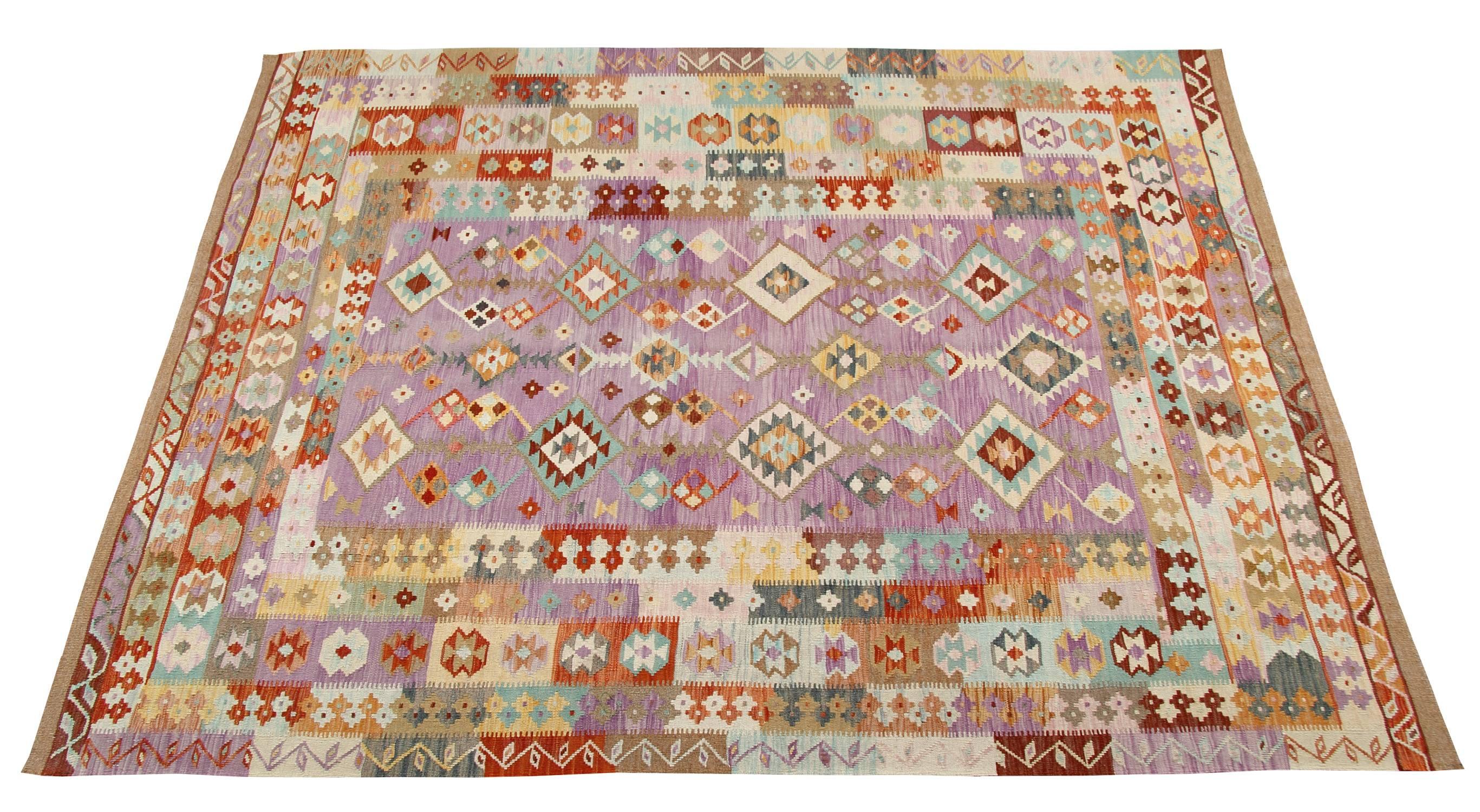 This flat-weave rug is new traditional Kilim rugs and a fascinating wool rug. In fact, it reports the designs of the traditional rugs but the manufacturer is new: it was geometric rug handmade in Afghanistan and uses tribal rug motifs. This purple